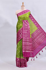 Green floral design mushru silk saree with contrast border and zari blouse