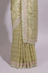Pastel yellow organza saree featuring delicate floral embroidery intricate lace detailing on the border and pallu with a scalloped finishing along with matching blouse