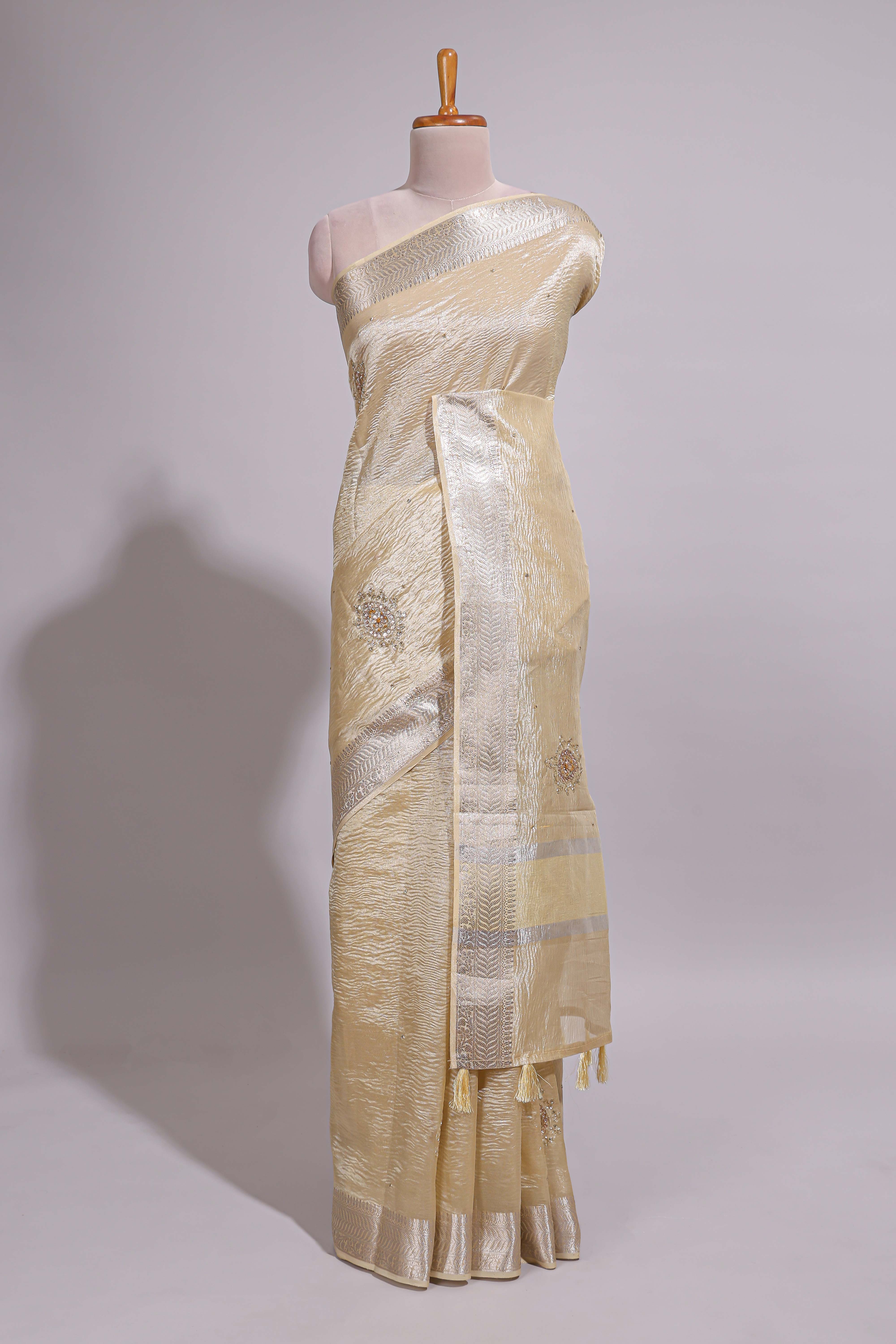 Cream organza saree featuring delicate floral embroidery intricate with silverborder along with blouse