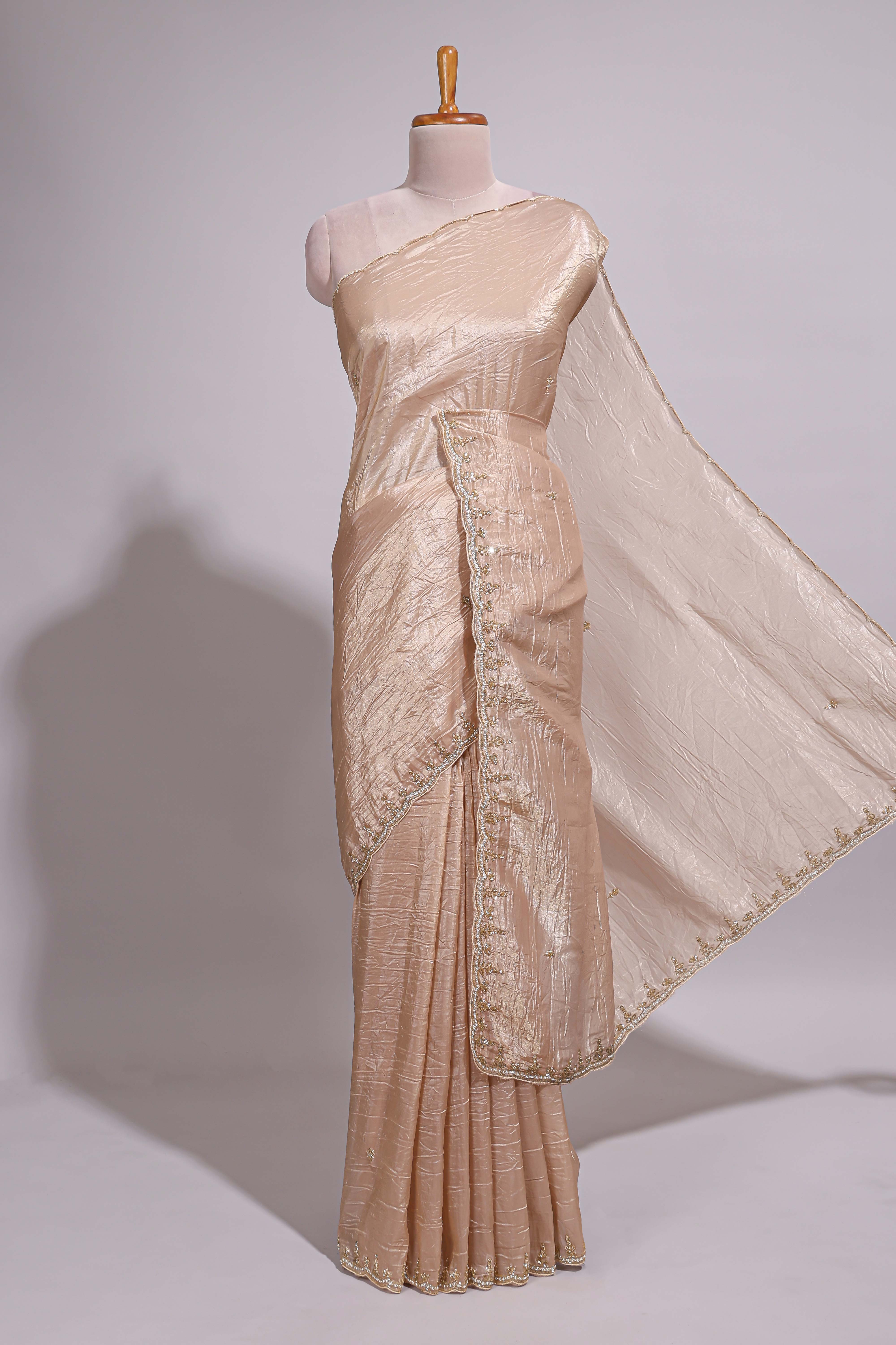Ivory beige organza saree with plain body border and pallu with a scalloped finishing along with matching blouse