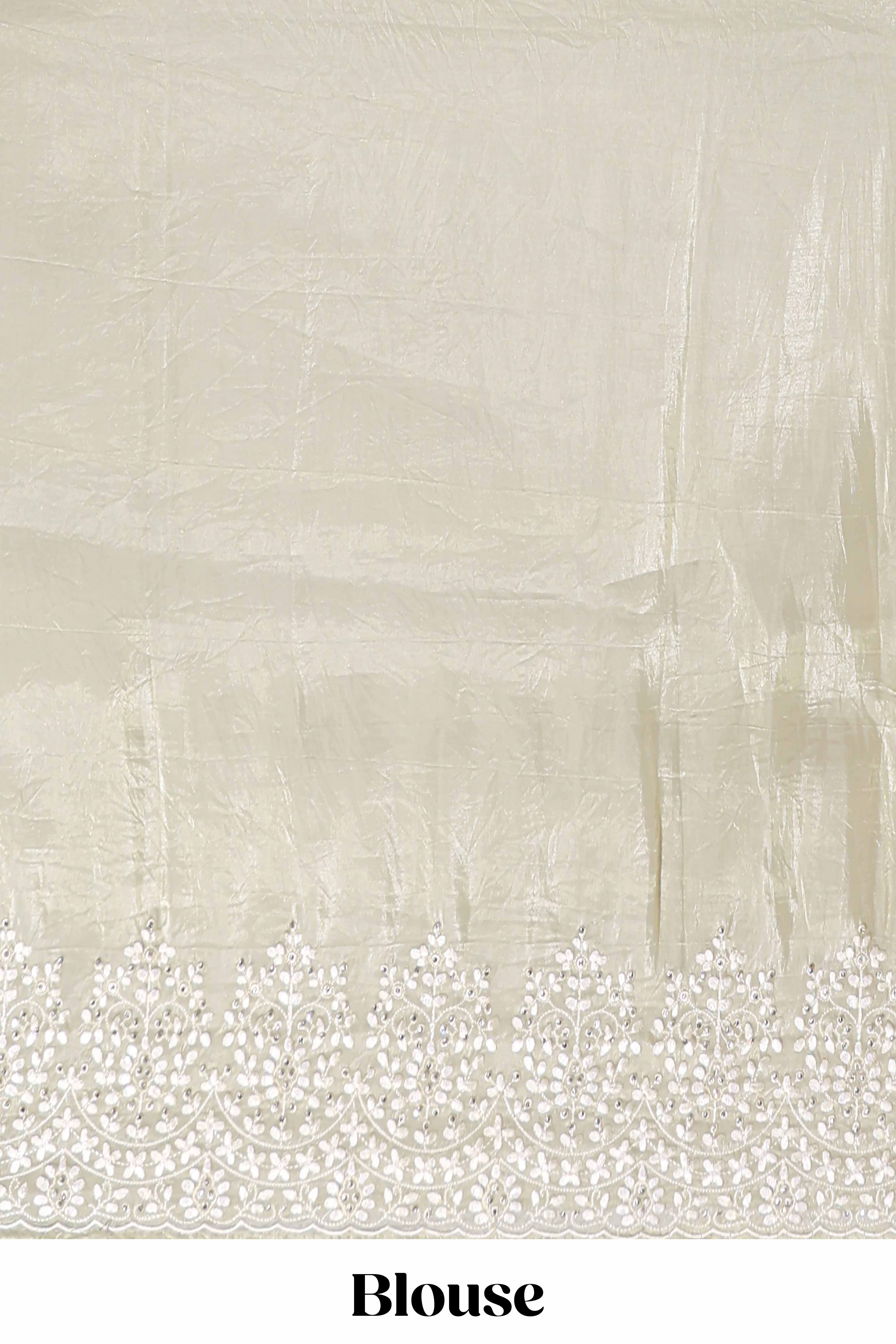 Pastel ivory organza saree with delicate floral embroidery intricate lace border and scalloped pallu detailing