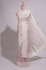 Soft blush pink organza saree with delicate floral embroidery intricate lace border and scalloped pallu detailing