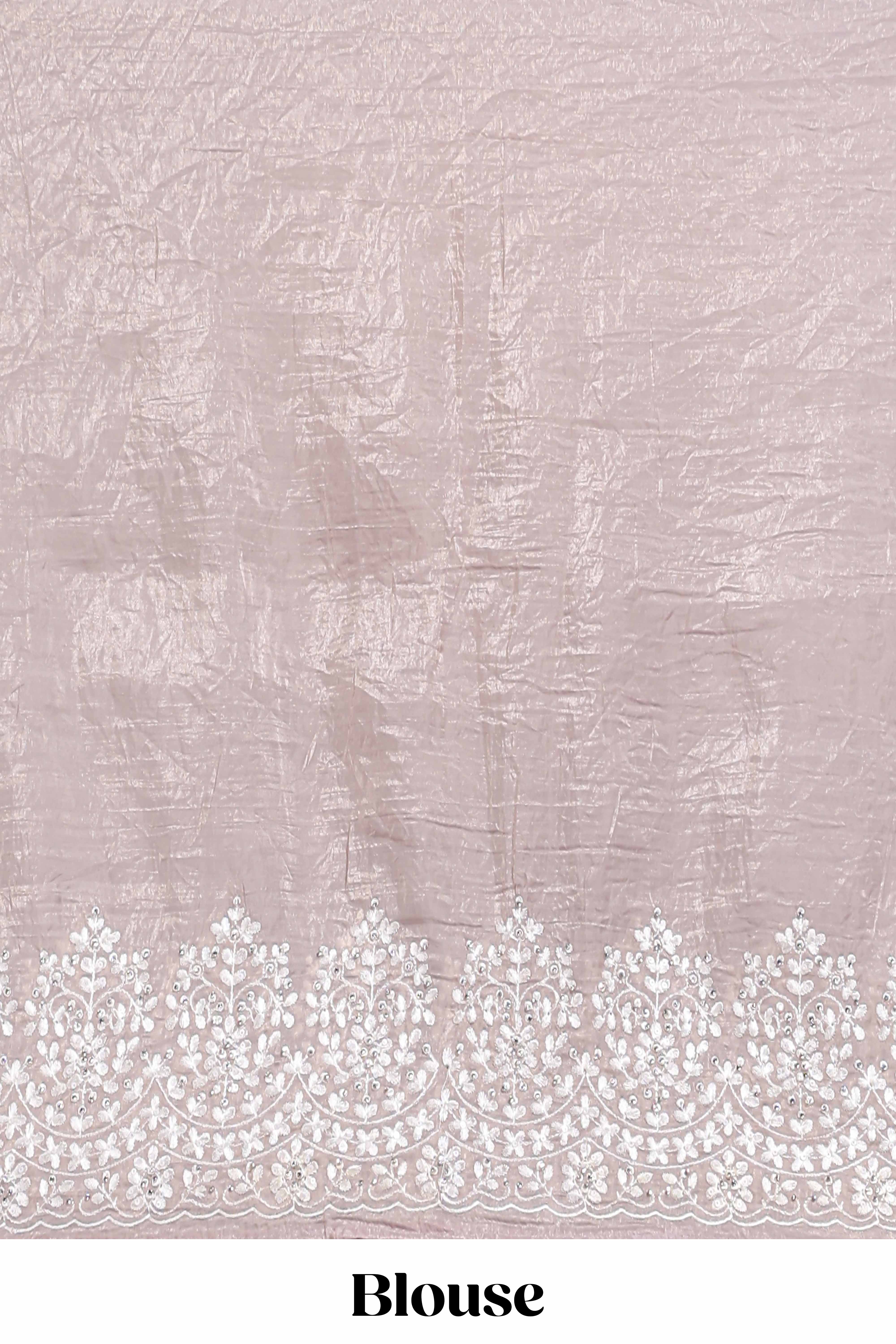 Soft blush pink organza saree with delicate floral embroidery intricate lace border and scalloped pallu detailing