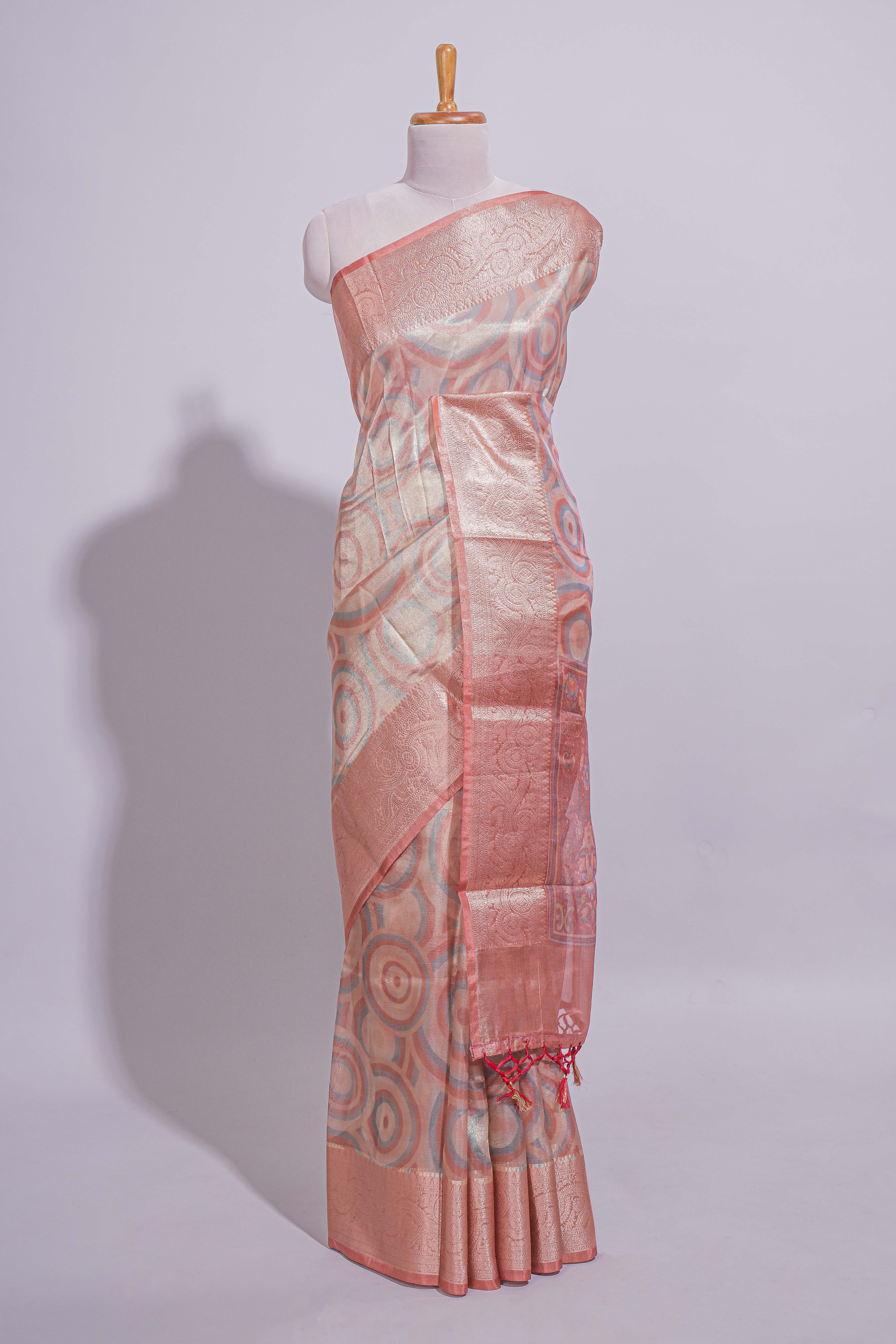 Peach Shade Geometric Design organza saree with Zari border and matching floral motifs blouse