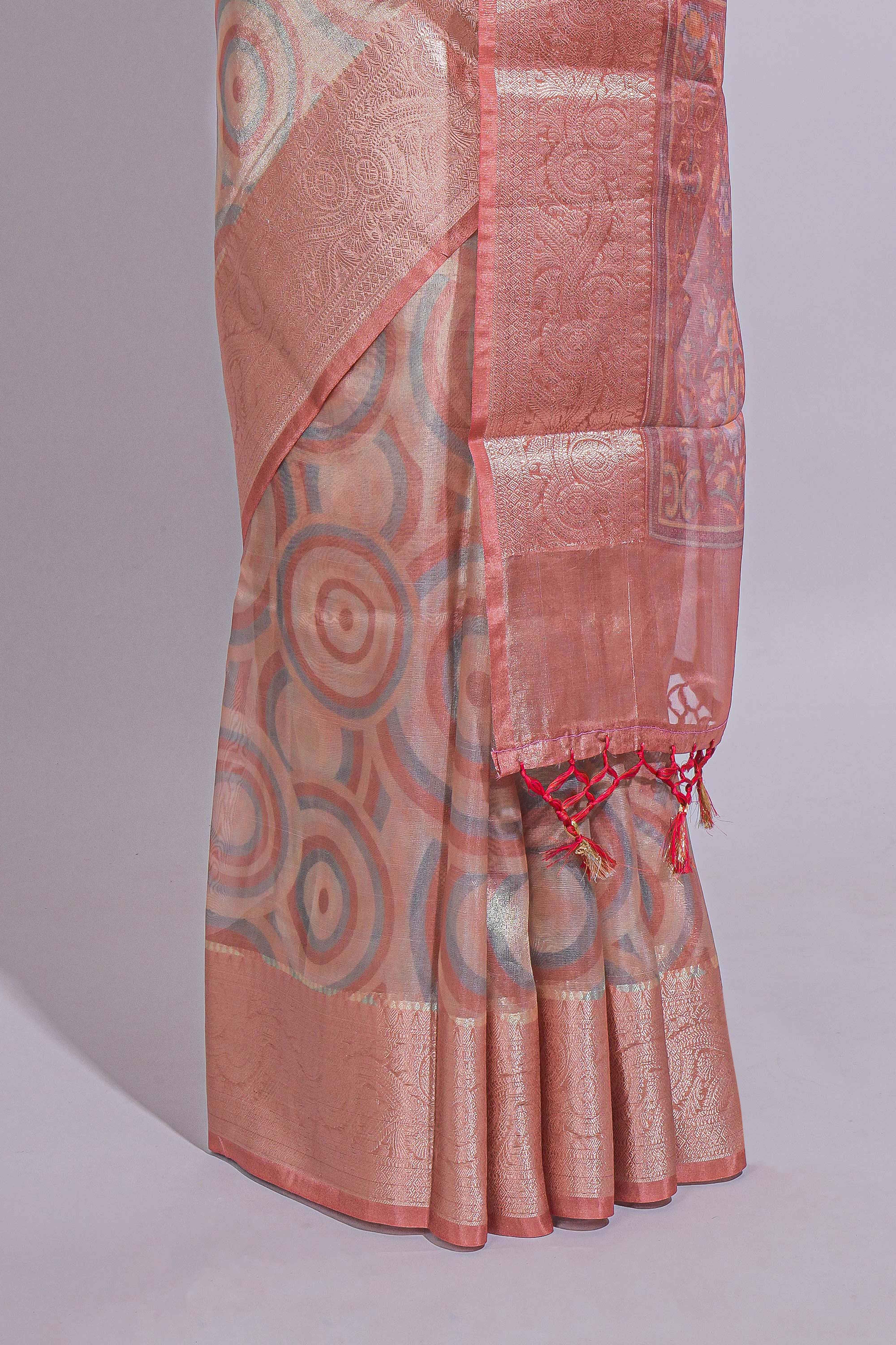 Peach Shade Geometric Design organza saree with Zari border and matching floral motifs blouse