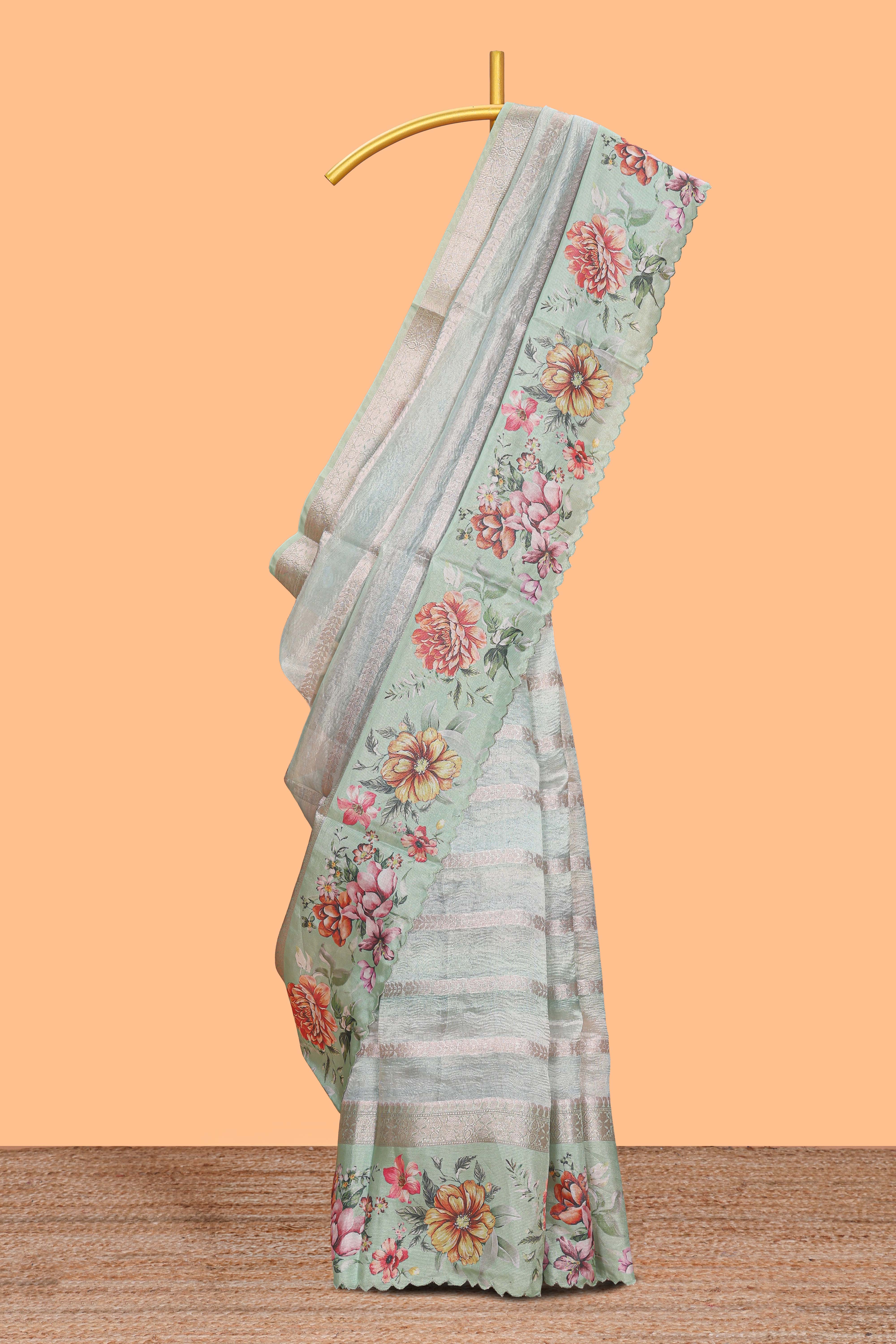 Green striped design organza saree with floral design border and matching floral motifs blouse