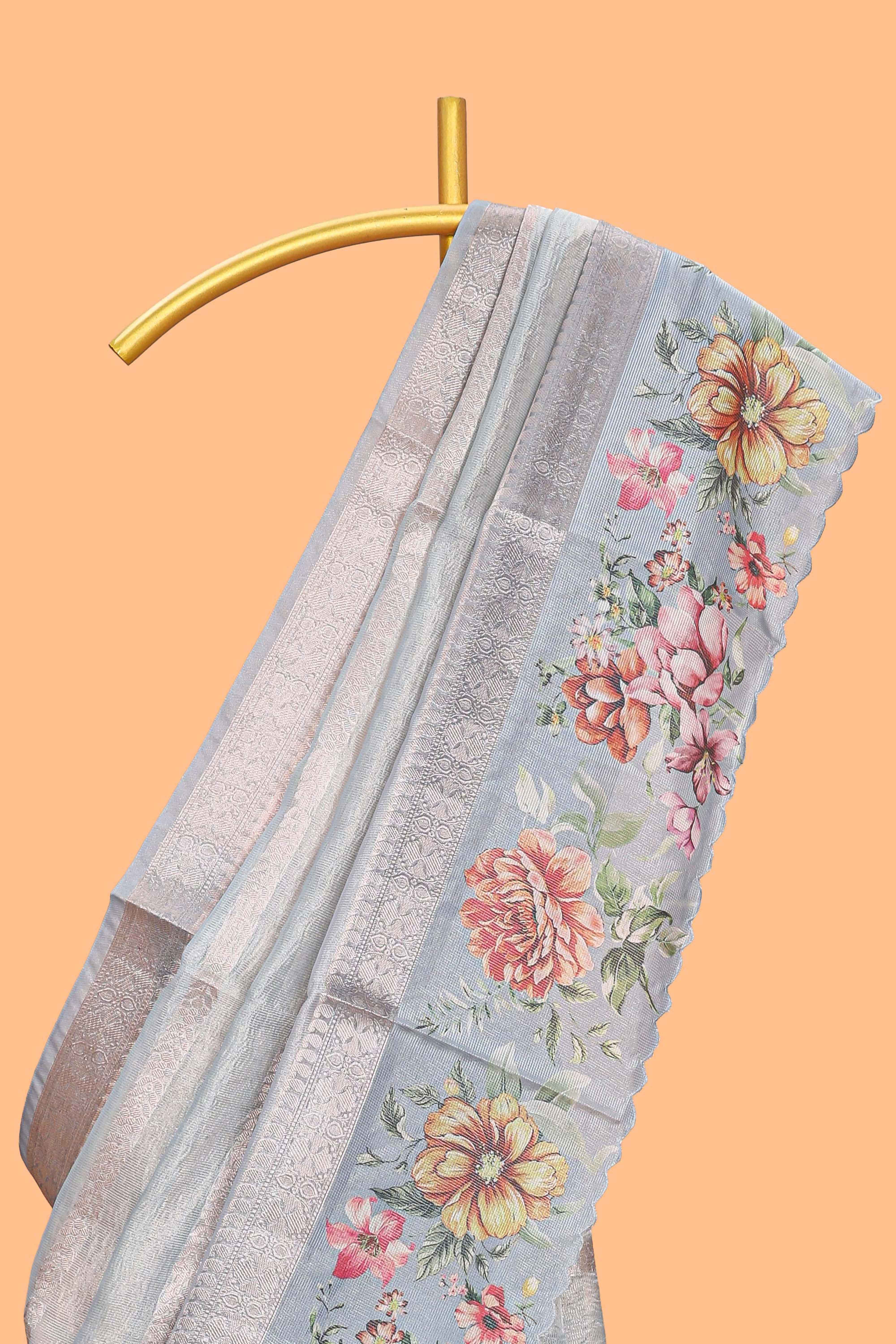 Grey shade striped design organza saree with floral design border and matching floral motifs blouse