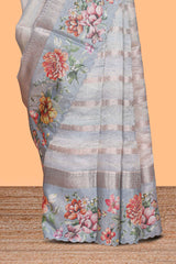 Grey shade striped design organza saree with floral design border and matching floral motifs blouse