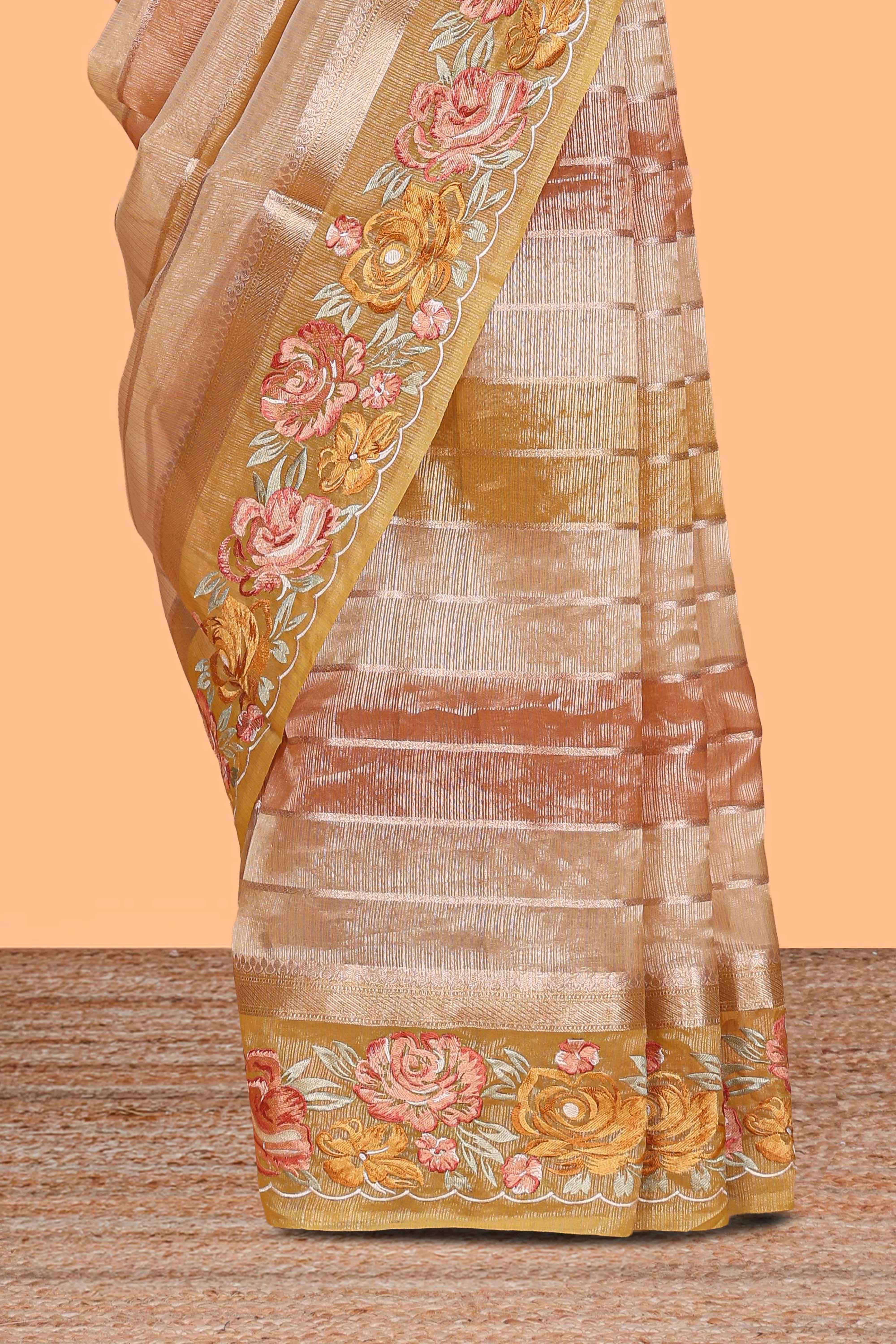 Peach gold striped art tissue saree with floral embroidered border and striped pallu