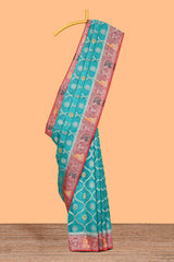 Turquoise blue floral design banarasi silk saree with contrast border and floral printed blouse