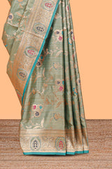 Green floral design banarasi silk saree with contrast border and floral printed blouse