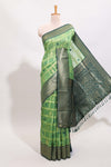 Green shade checked and butta banarasi silk saree with contrast geometric zari border and buttas blouse