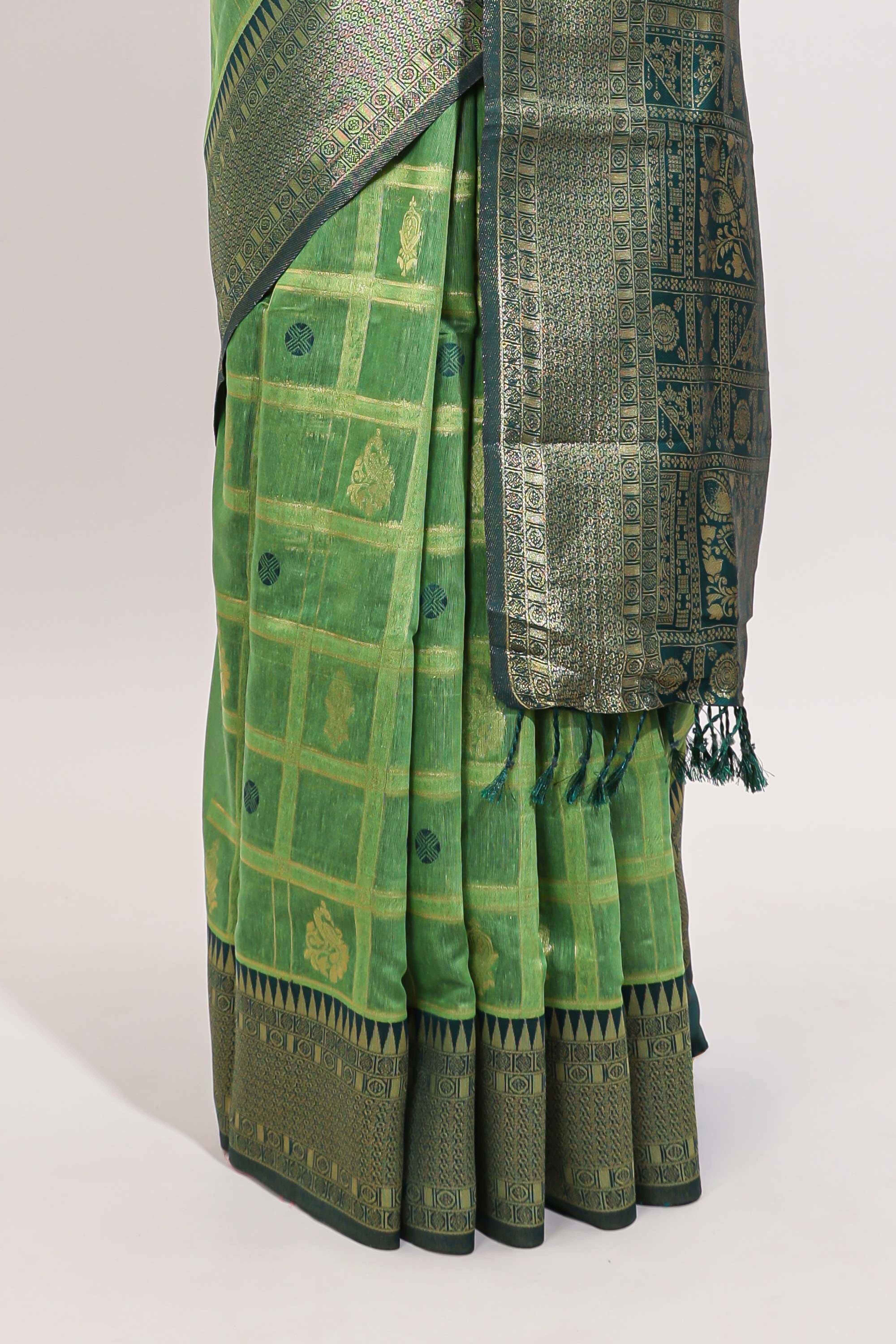 Green shade checked and butta banarasi silk saree with contrast geometric zari border and buttas blouse