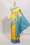 Yellow shade checked and butta banarasi silk saree with teal blue contrast zari border and buttas blouse