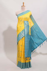 Yellow shade checked and butta banarasi silk saree with teal blue contrast zari border and buttas blouse