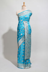 Blue shade floral designed banarasi silk saree with self zari border and blouse