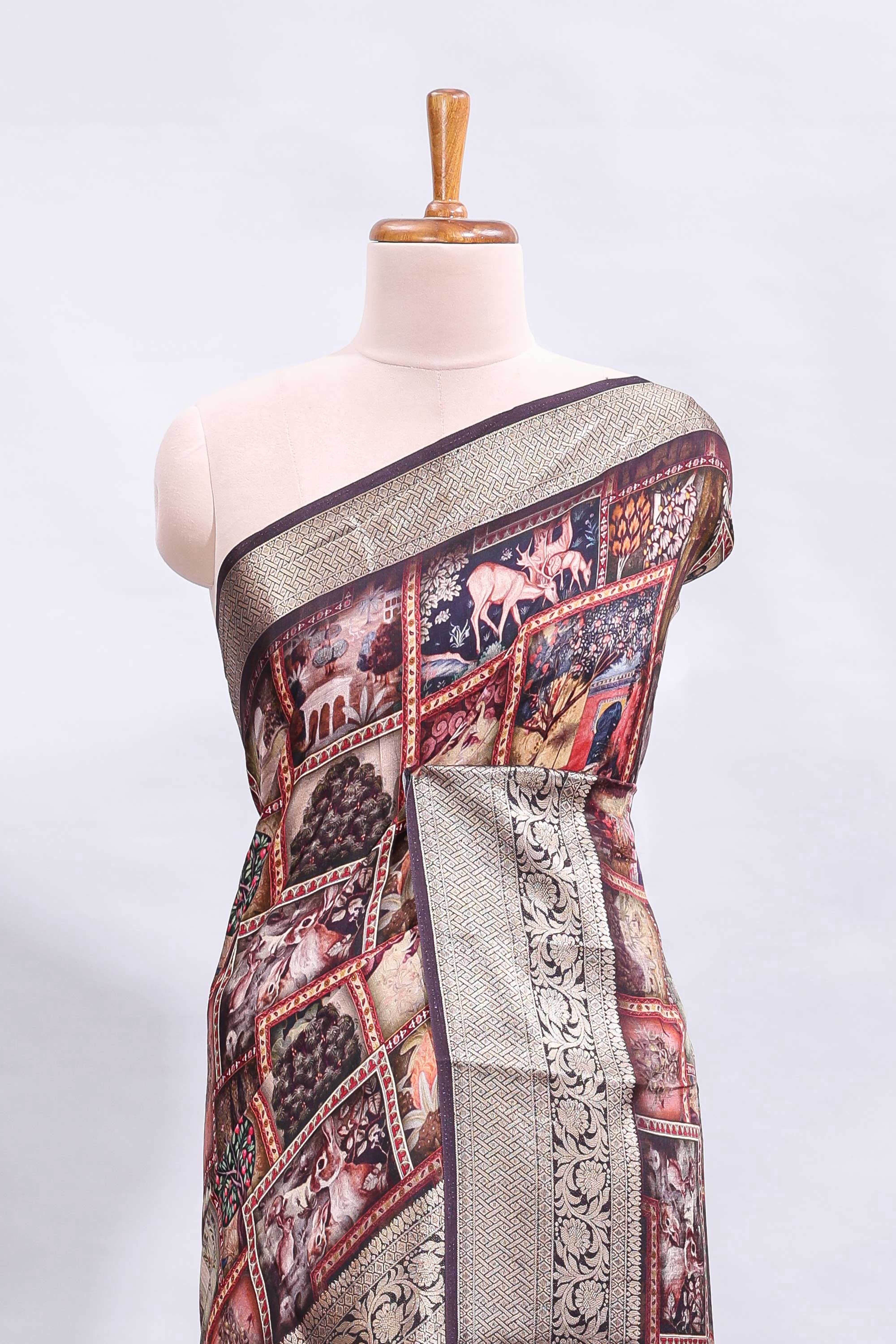 Maroon printed saree with traditional art motifs with contrast zari border and motifs blouse