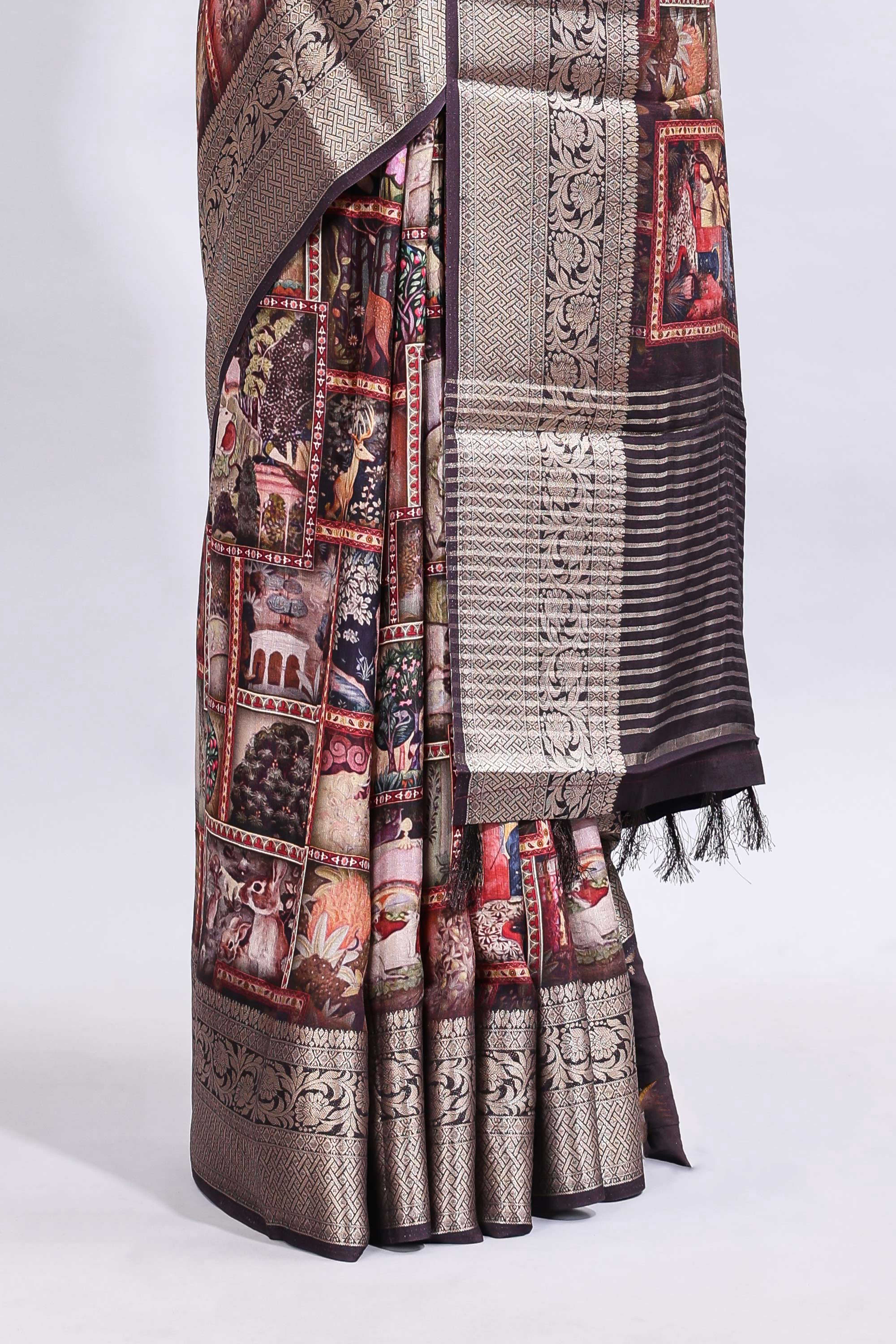 Maroon printed saree with traditional art motifs with contrast zari border and motifs blouse