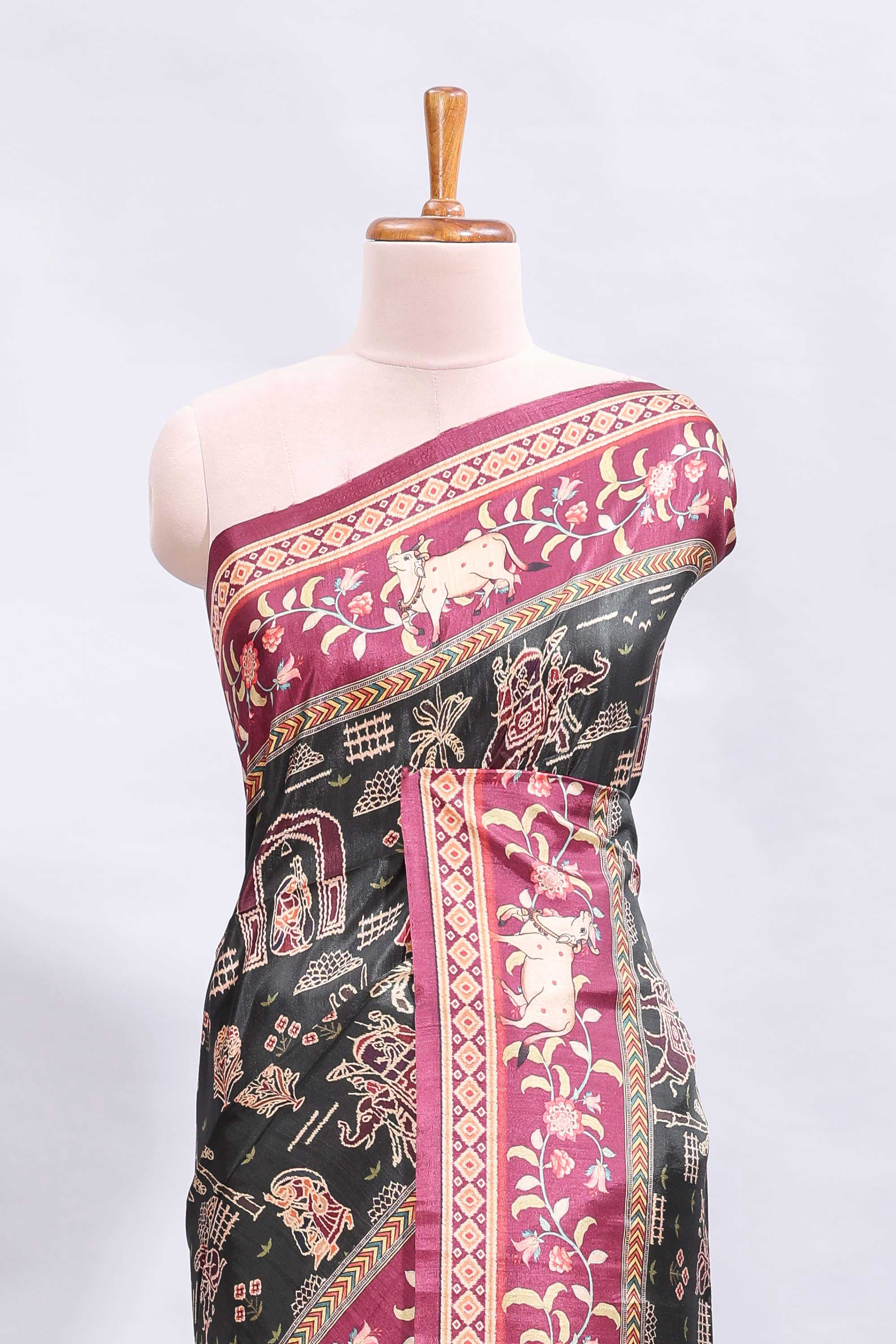 Black traditional theme printed saree with contrast floral & cow design border and plain blouse