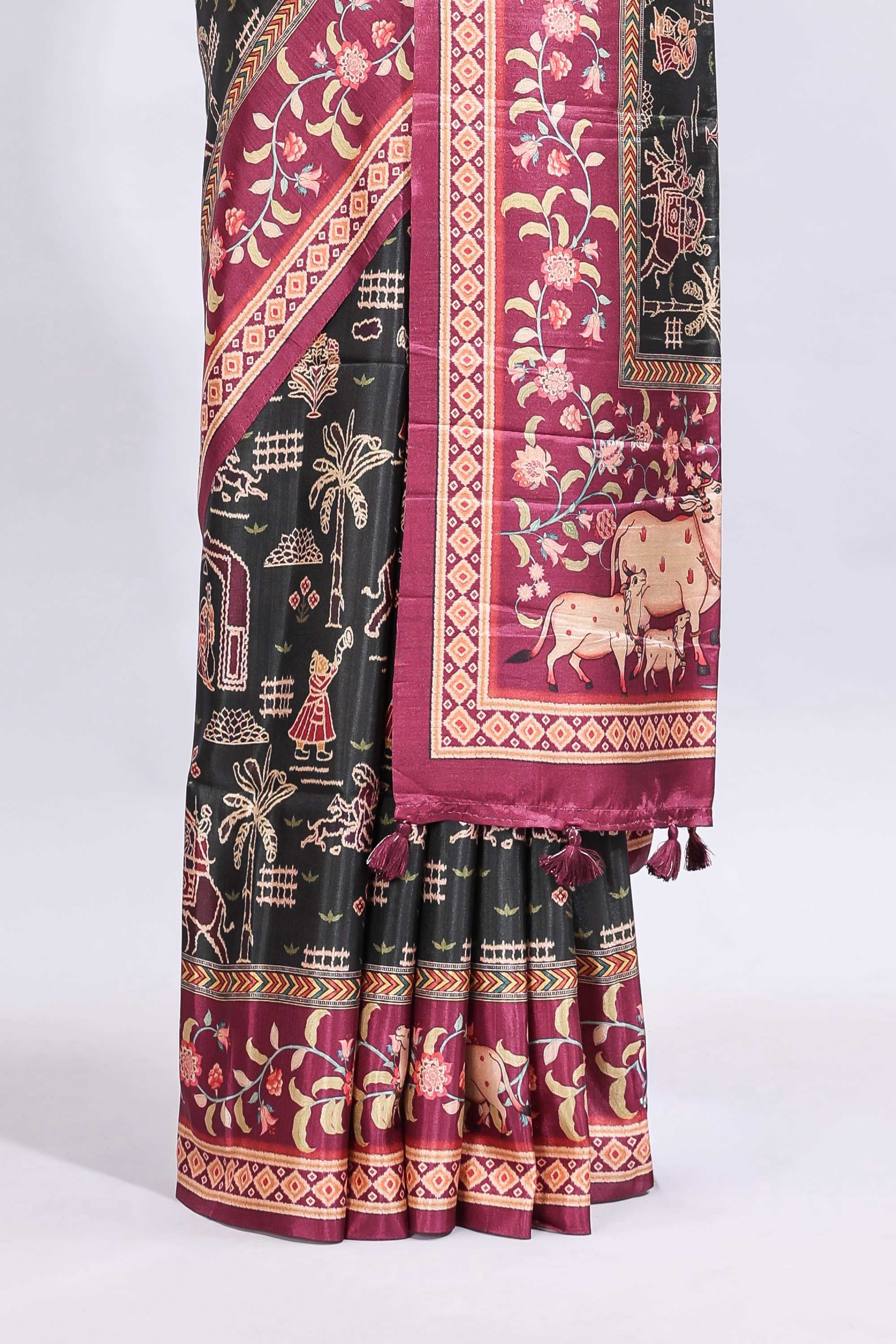 Black traditional theme printed saree with contrast floral & cow design border and plain blouse