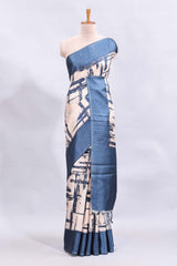 Cream abstract printed saree with contrast checked border and blouse