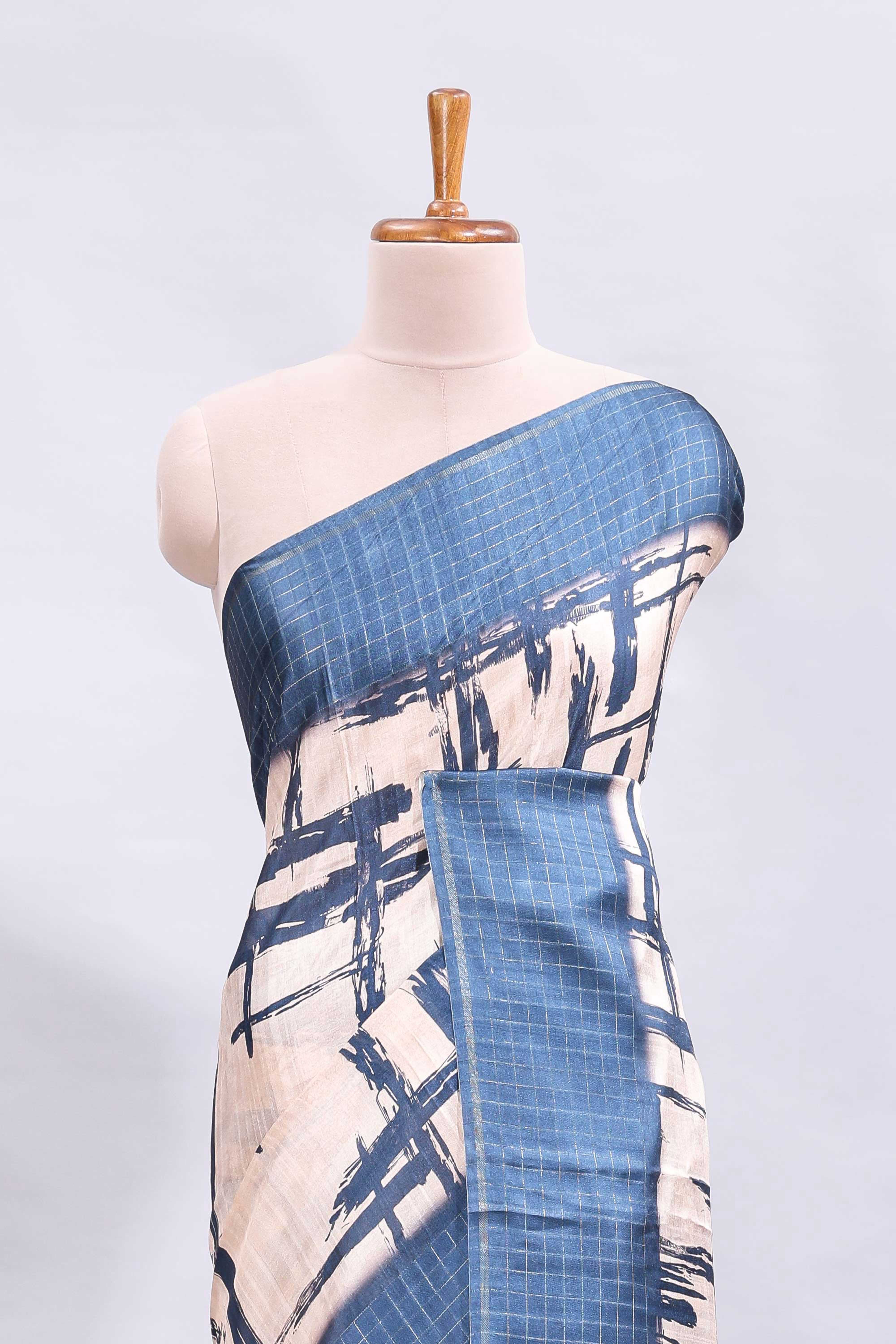 Cream abstract printed saree with contrast checked border and blouse