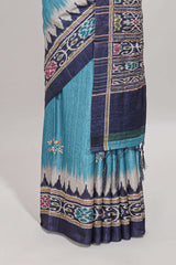Blue ikkat style floral motifs tussar saree with contrast border and crane bird motif blouse