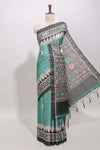 Green ikkat style floral motifs tussar saree with contrast border and crane bird motif blouse