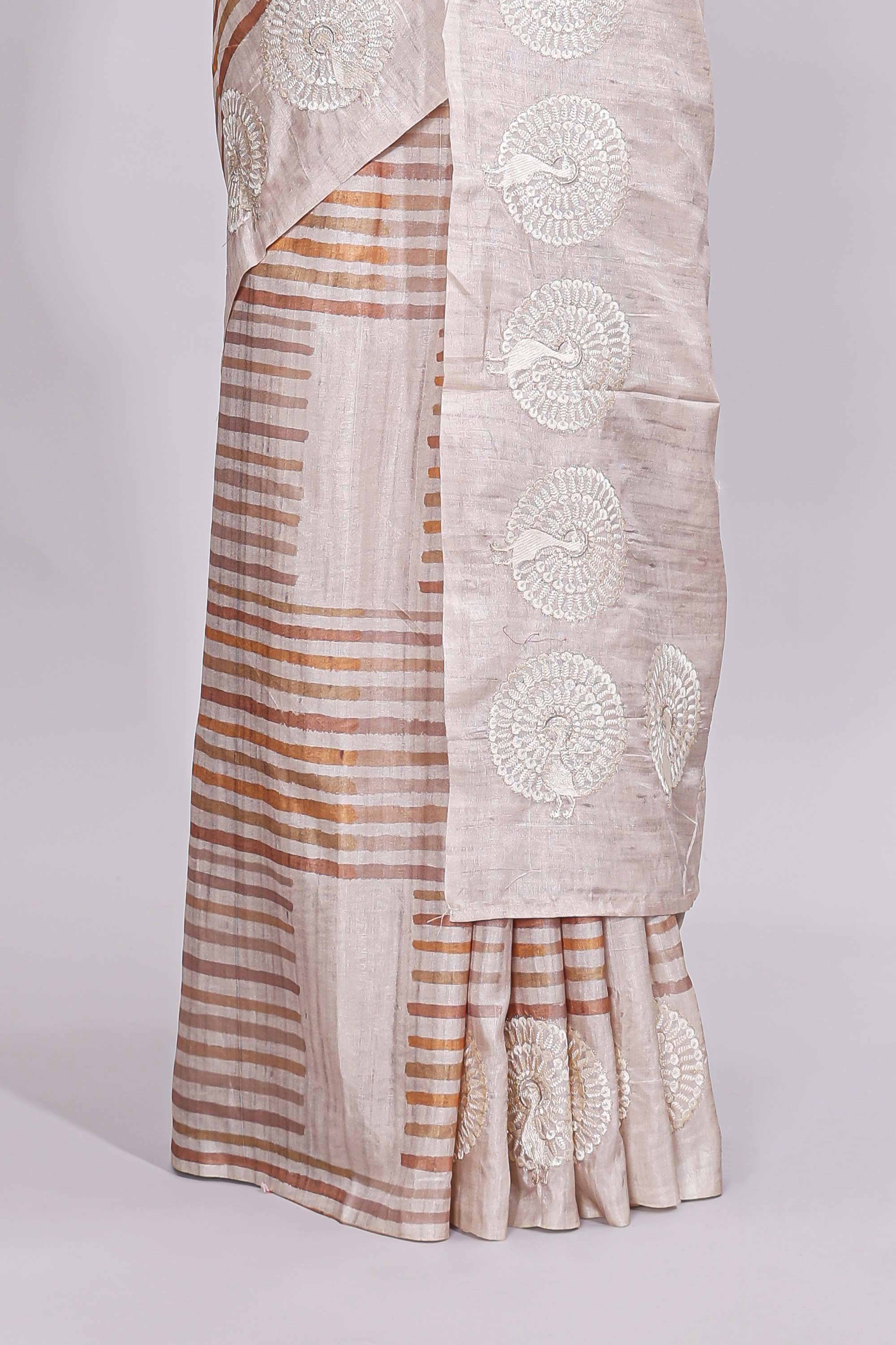 Beige striped design raw silk saree with self border and matching blouse