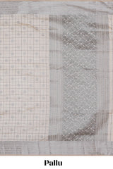 Off white checked zari design raw silk saree with self zari border and matching striped blouse
