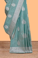 Green floral zari design raw silk saree with self zari border and matching motifs blouse