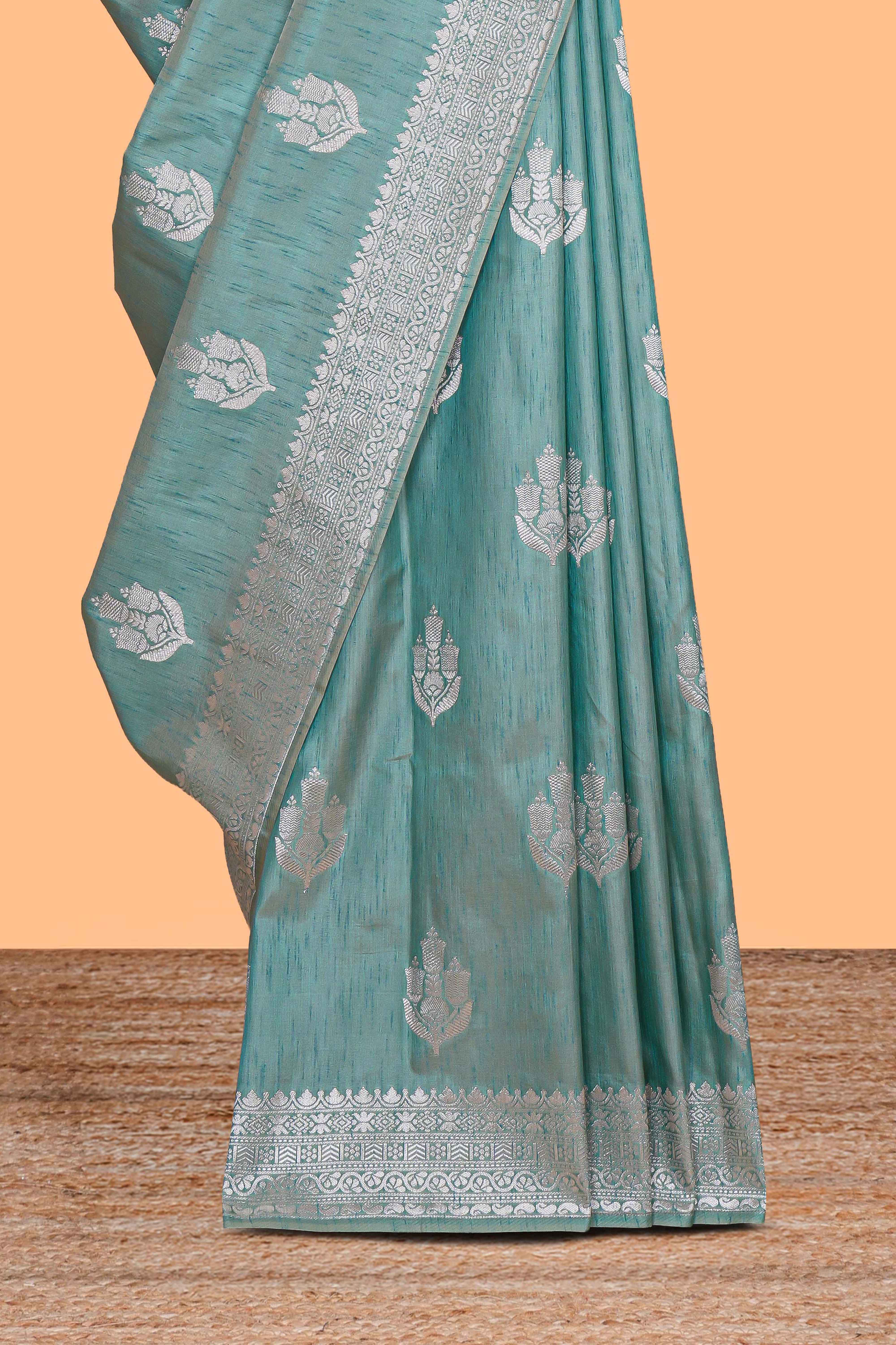 Green floral zari design raw silk saree with self zari border and matching motifs blouse