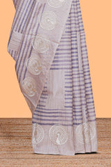 Off white striped design raw silk saree with self peacock design embroidery border and matching checked blouse