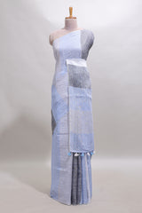 Light sky blue south cotton saree body with broad grey contrast borders and a matching striped pallu finished with tassels with a matching blouse piece