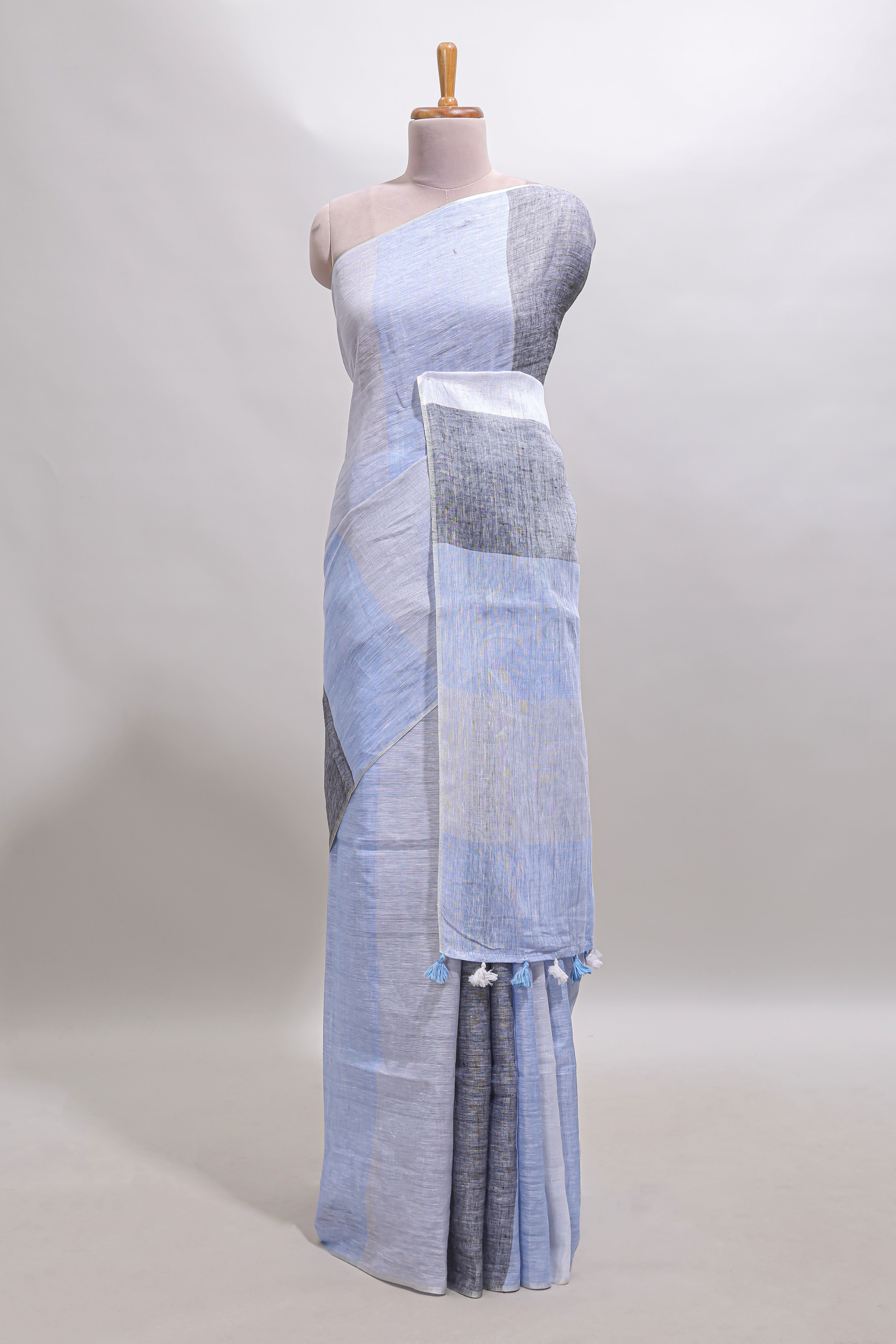 Light sky blue south cotton saree body with broad grey contrast borders and a matching striped pallu finished with tassels with a matching blouse piece