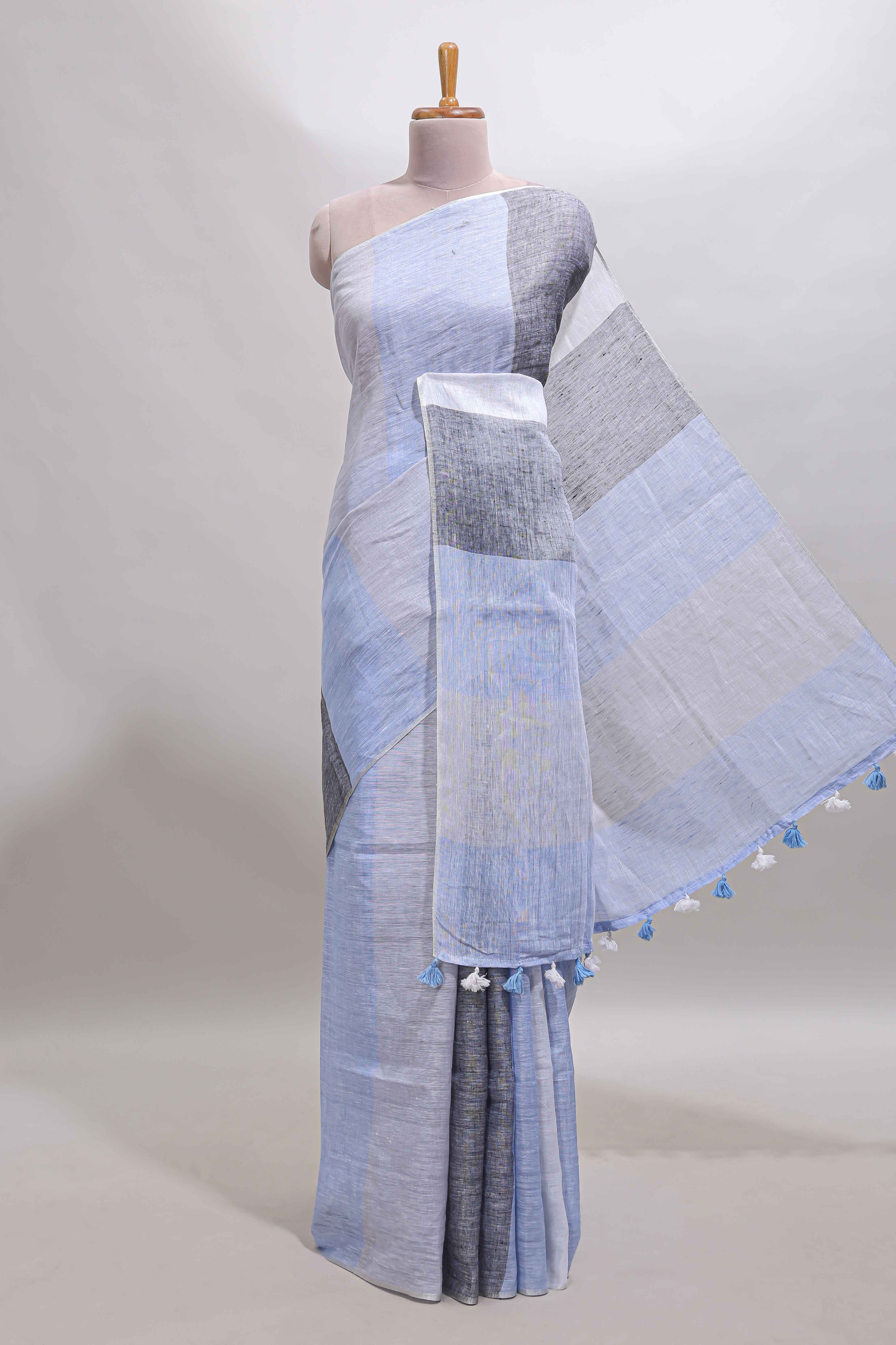 Light sky blue south cotton saree body with broad grey contrast borders and a matching striped pallu finished with tassels with a matching blouse piece