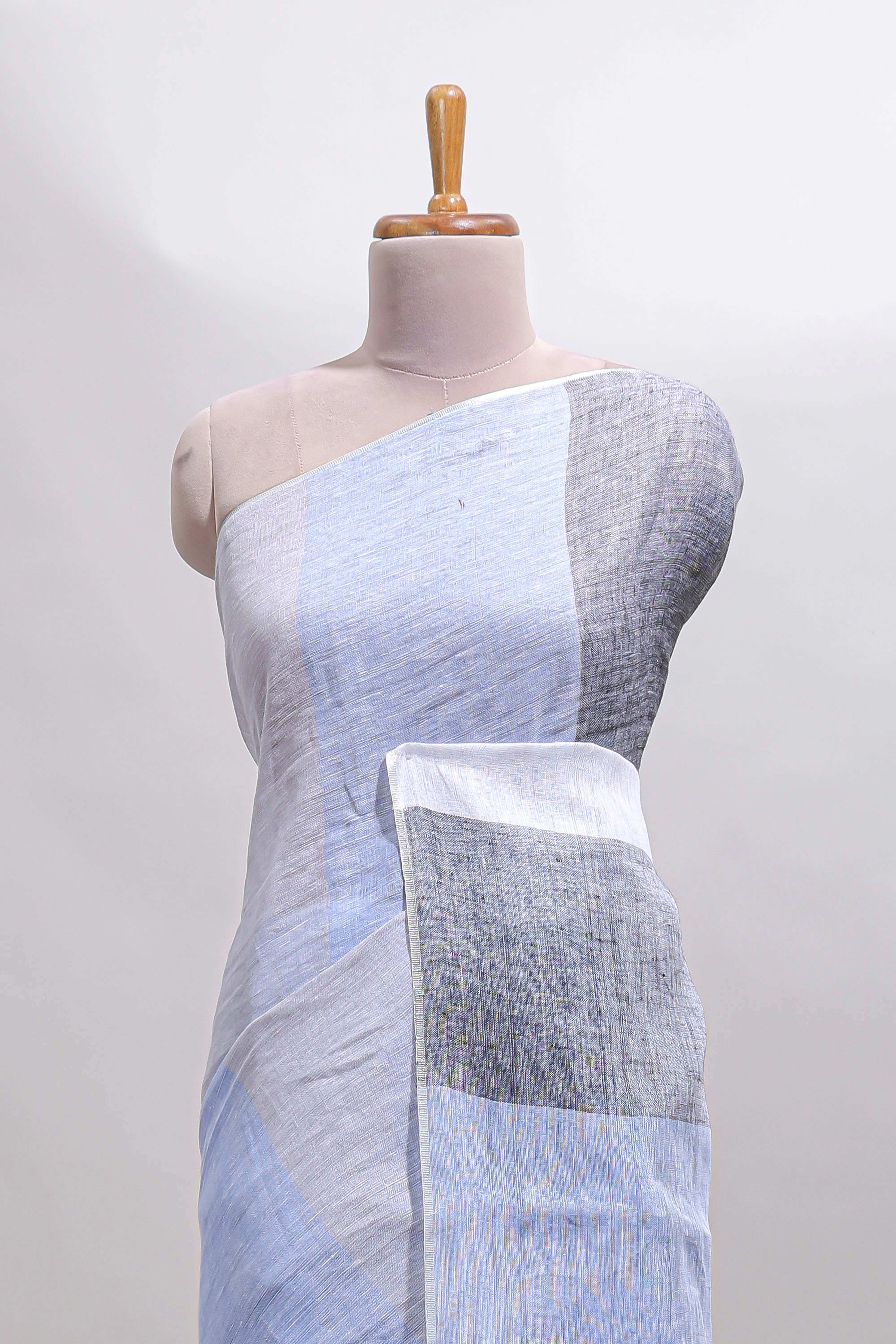 Light sky blue south cotton saree body with broad grey contrast borders and a matching striped pallu finished with tassels with a matching blouse piece