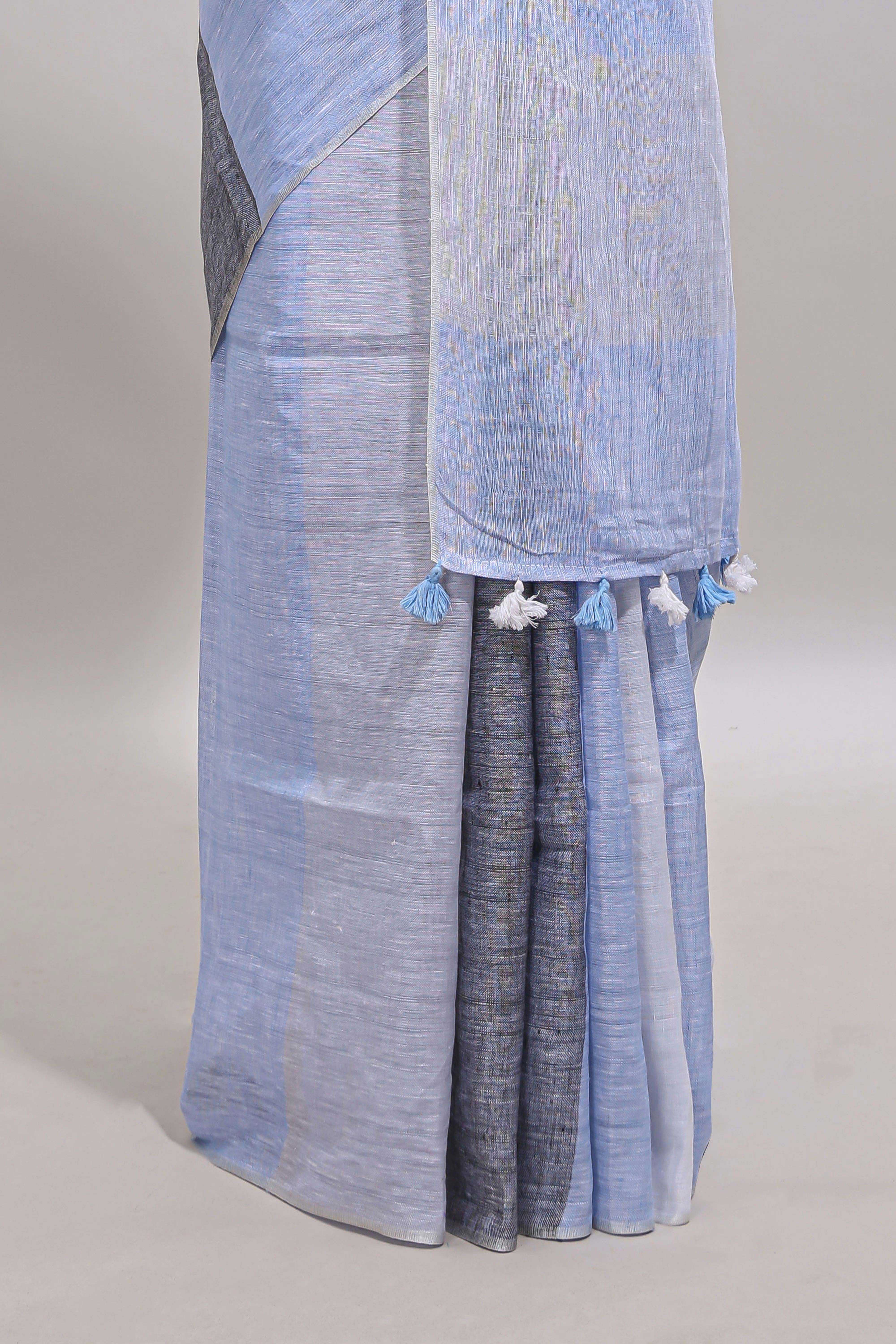 Light sky blue south cotton saree body with broad grey contrast borders and a matching striped pallu finished with tassels with a matching blouse piece