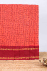 Peach tamil letters print sungudi cotton saree with contrast border and striped pallu