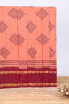 Peach traditional kolam print sungudi cotton saree with contrast border and striped pallu