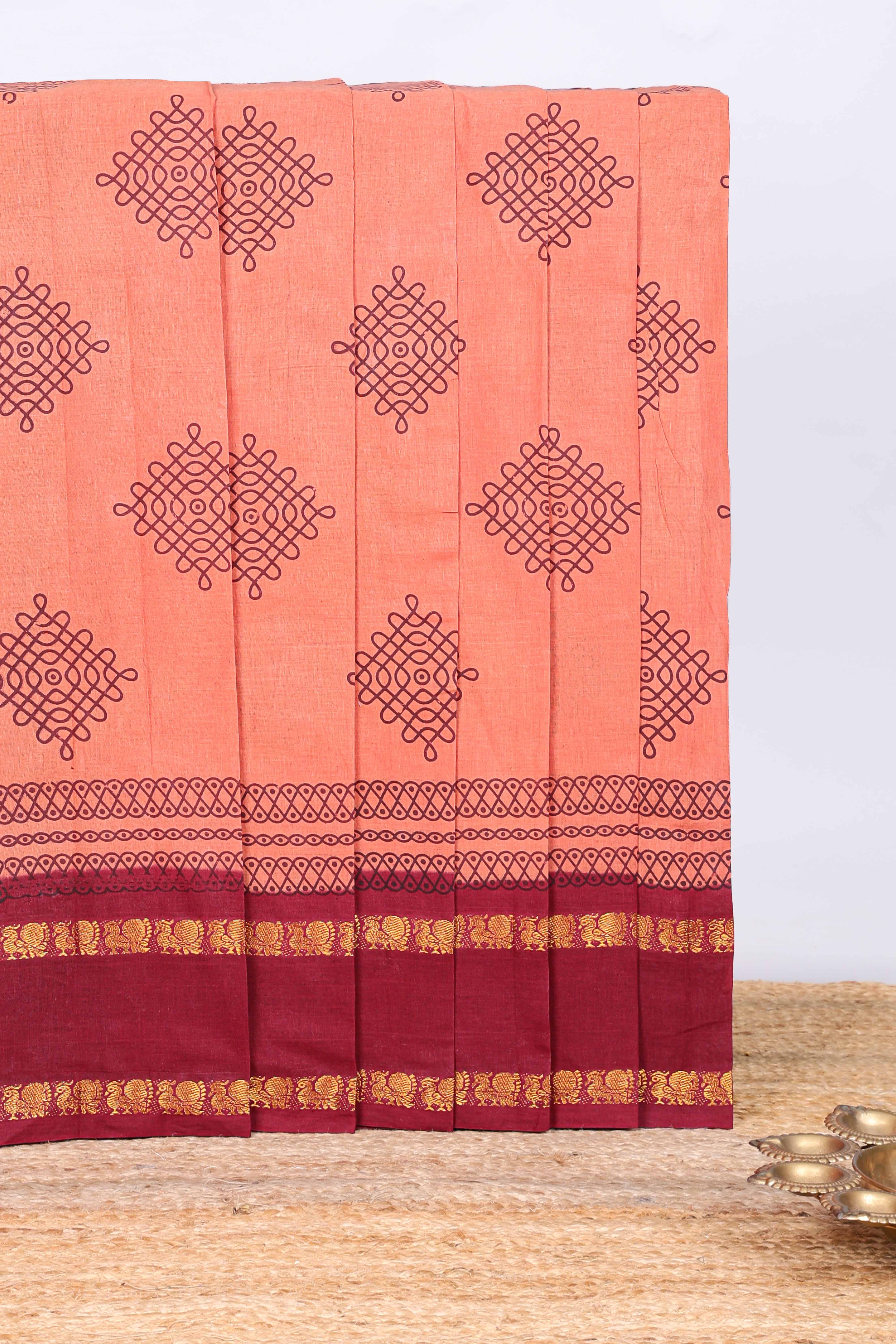 Peach traditional kolam print sungudi cotton saree with contrast border and striped pallu