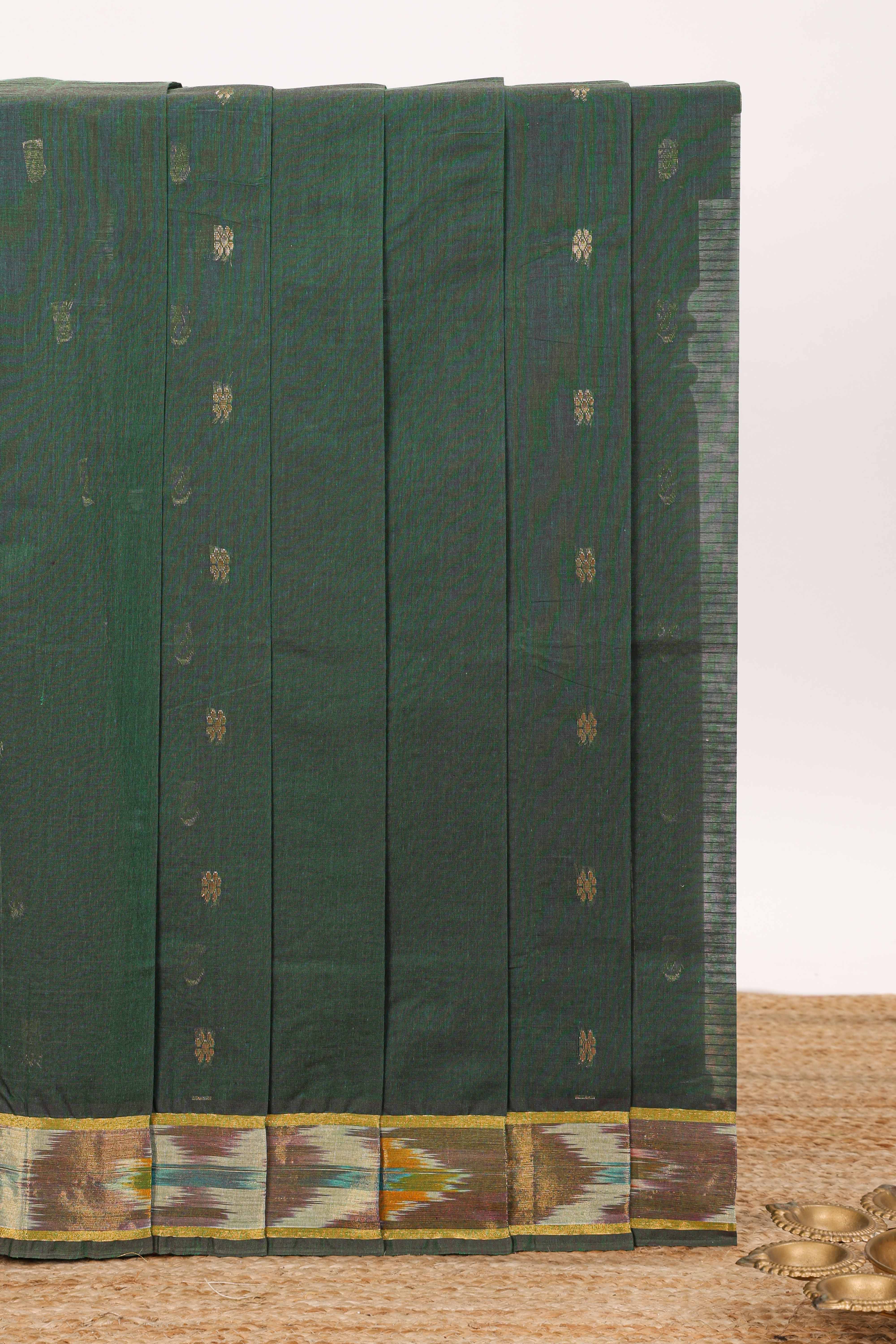 Dark green butta designed silk cotton saree with self zari border and contrast blouse