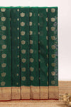 Dark green butta designed silk cotton saree with contrast zari border and blouse