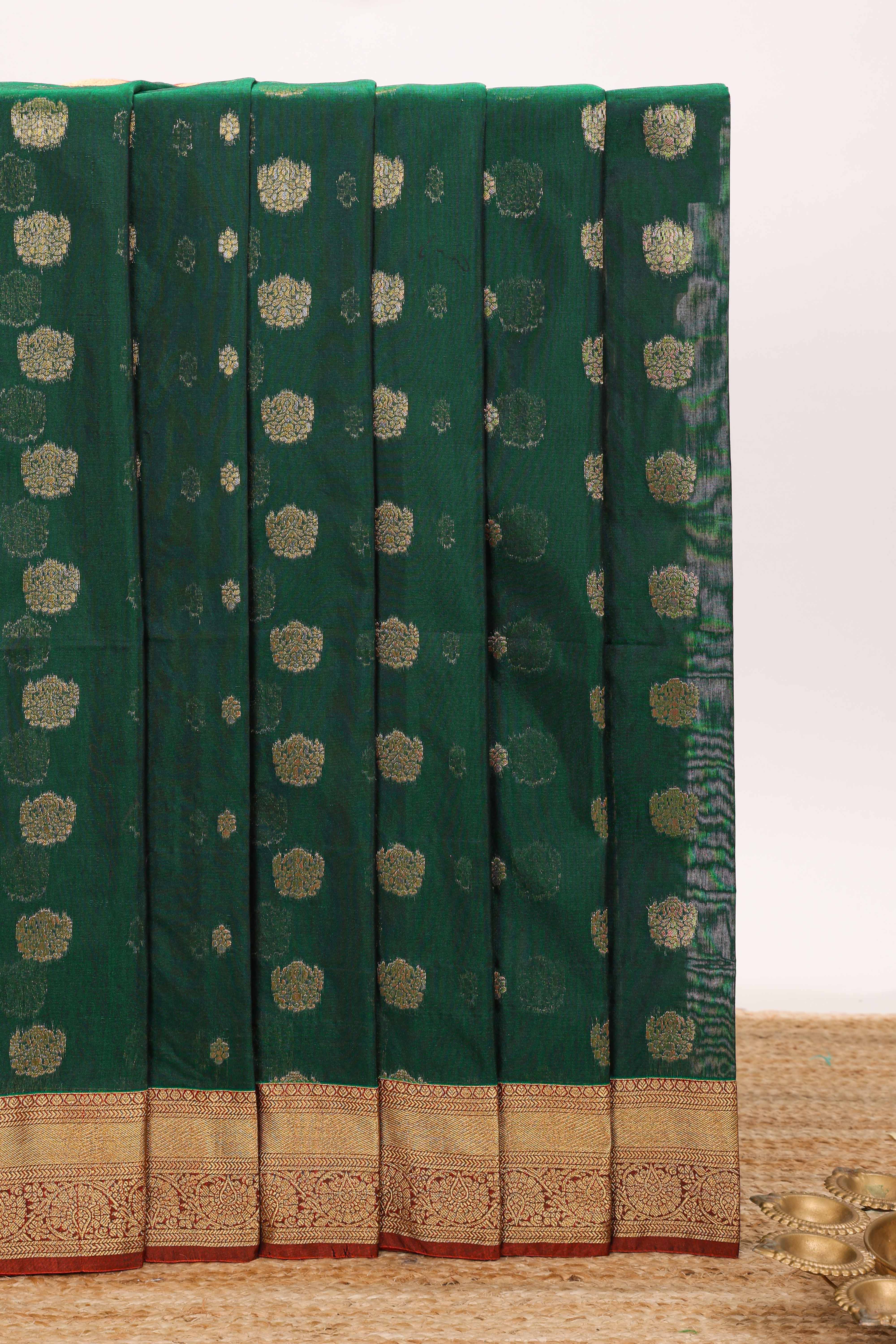 Dark green butta designed silk cotton saree with contrast zari border and blouse