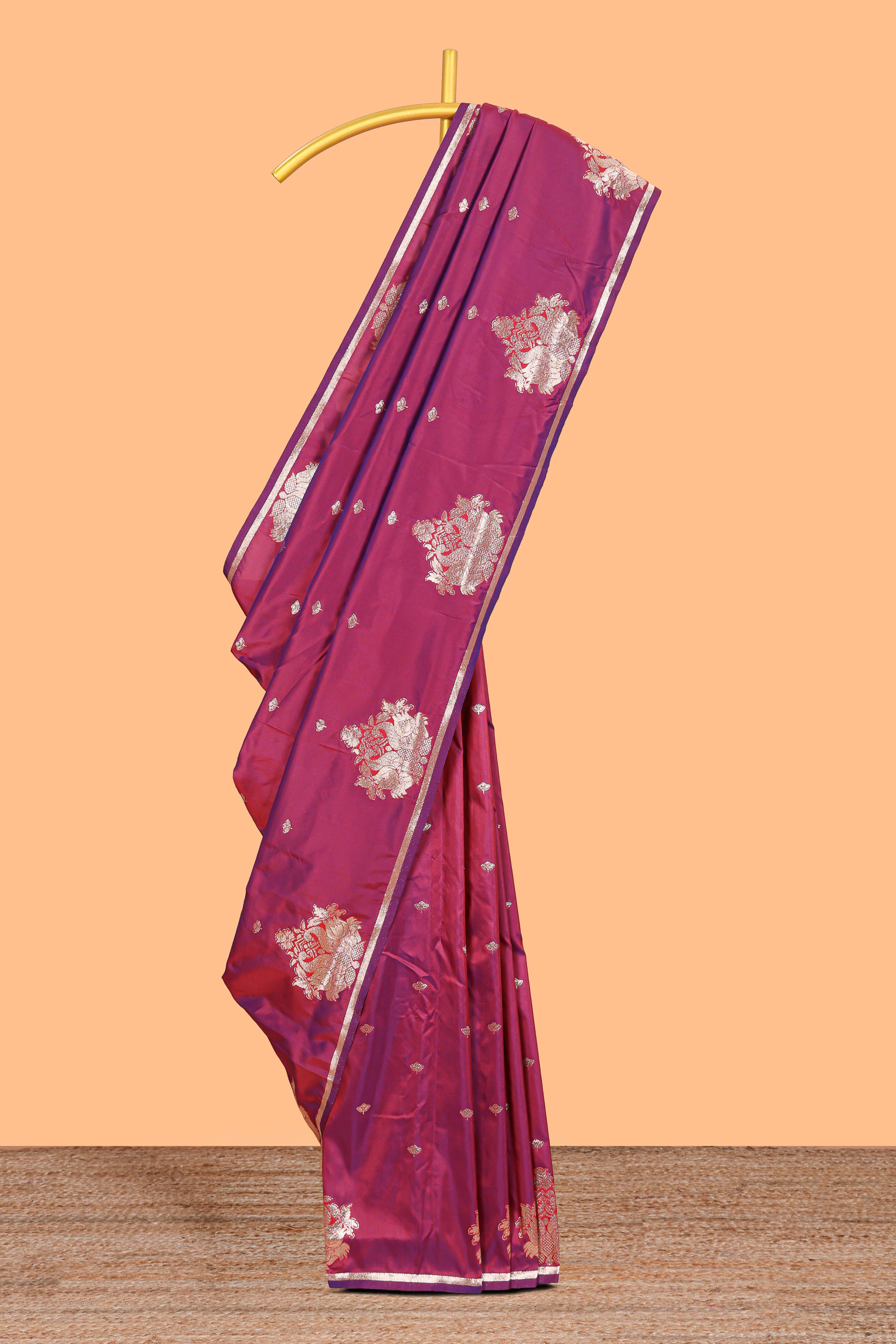 Magenta colour Semi soft silk withgold zari floral motifs border with peacock motifs and matching blouse