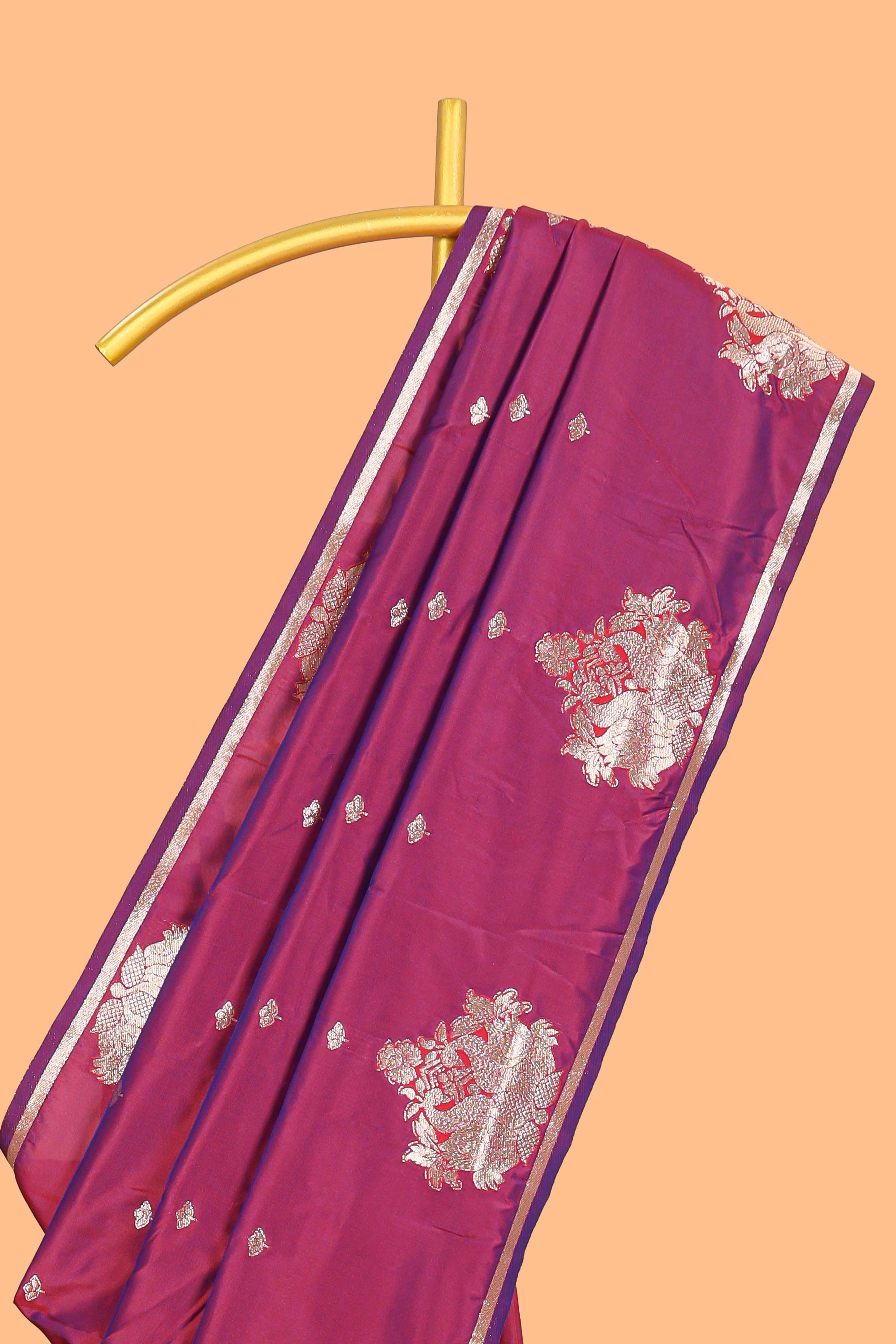 Magenta colour Semi soft silk withgold zari floral motifs border with peacock motifs and matching blouse