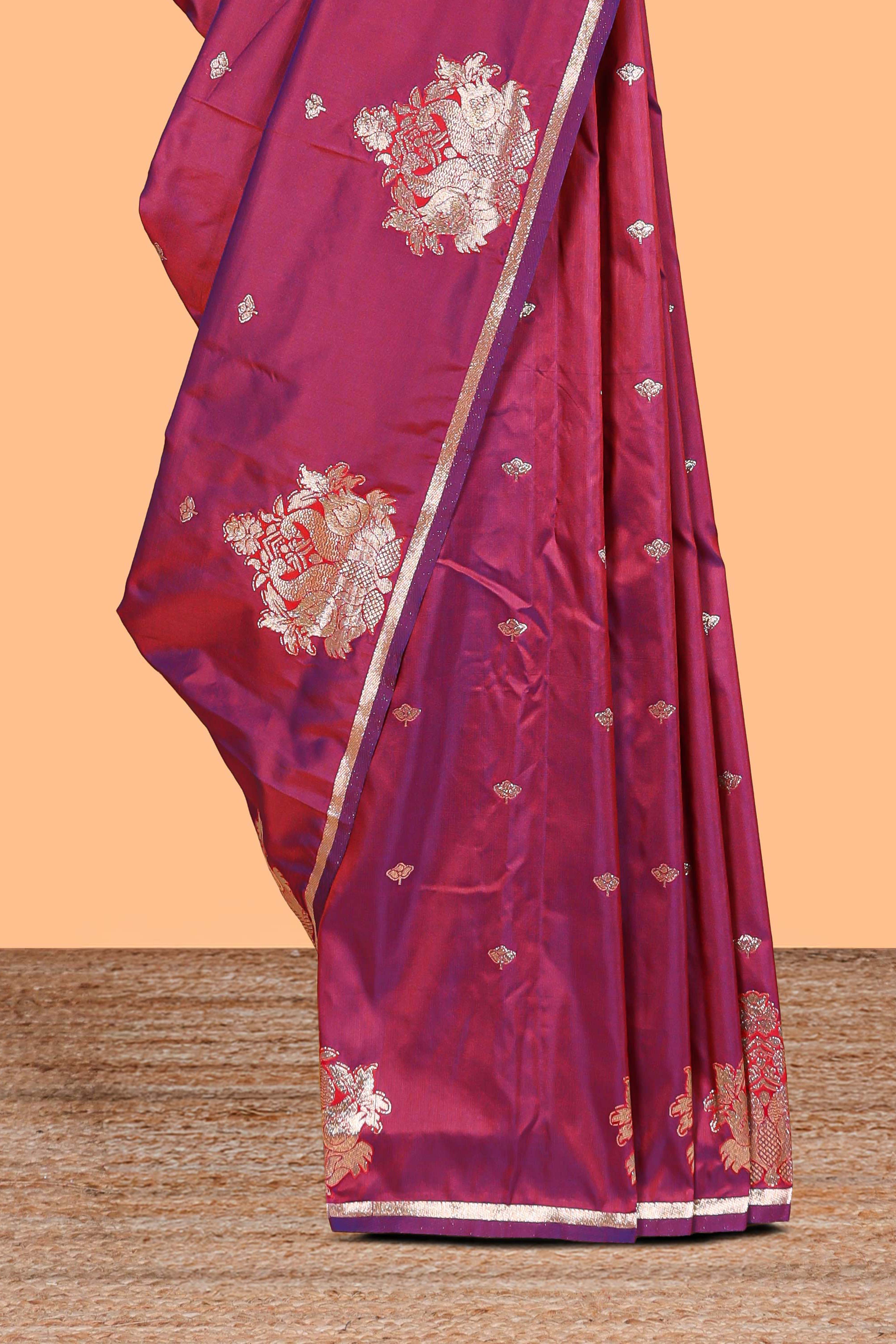 Magenta colour Semi soft silk withgold zari floral motifs border with peacock motifs and matching blouse