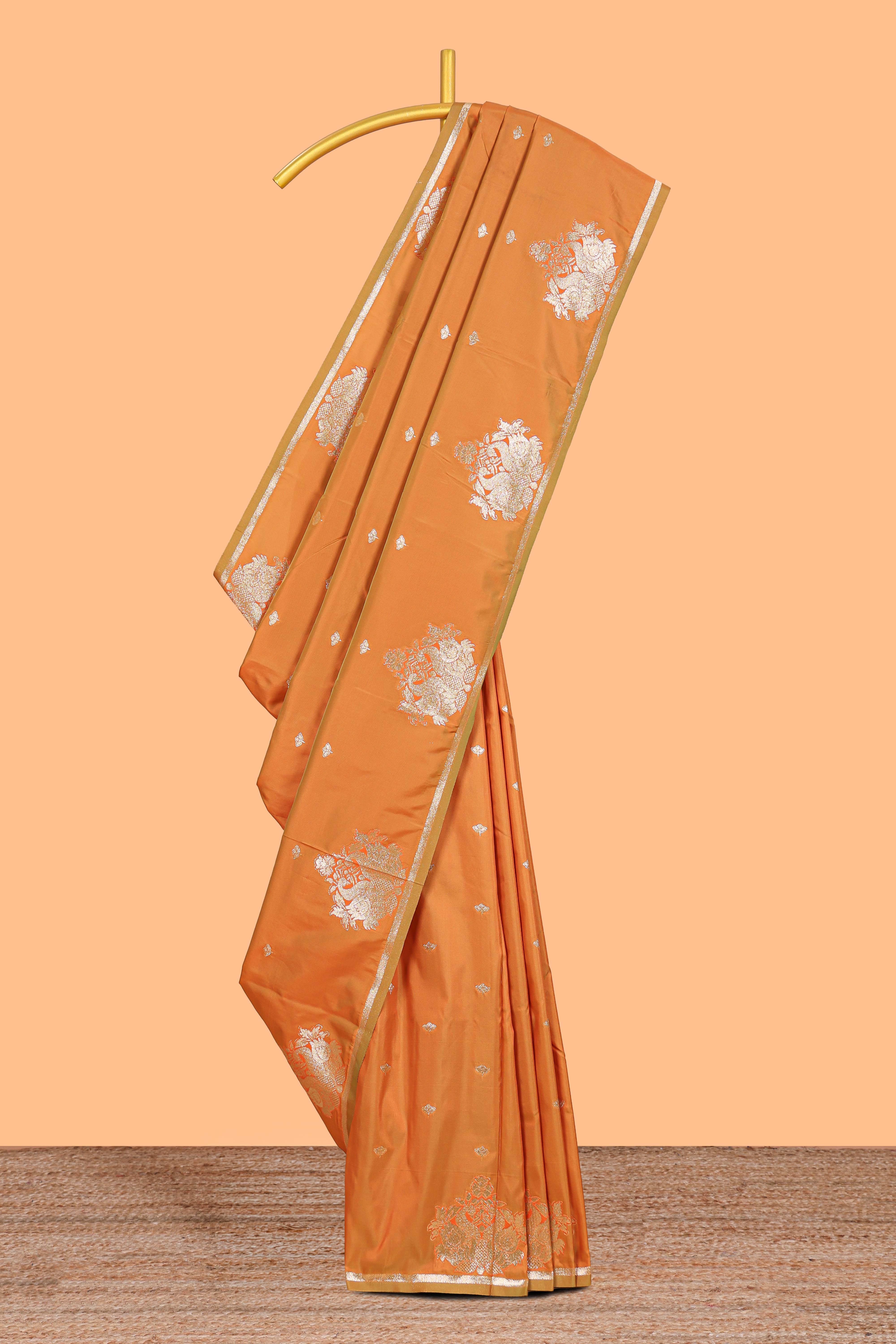Rust Orange colour Semi soft silk withgold zari floral motifs border with peacock motifs and matching blouse