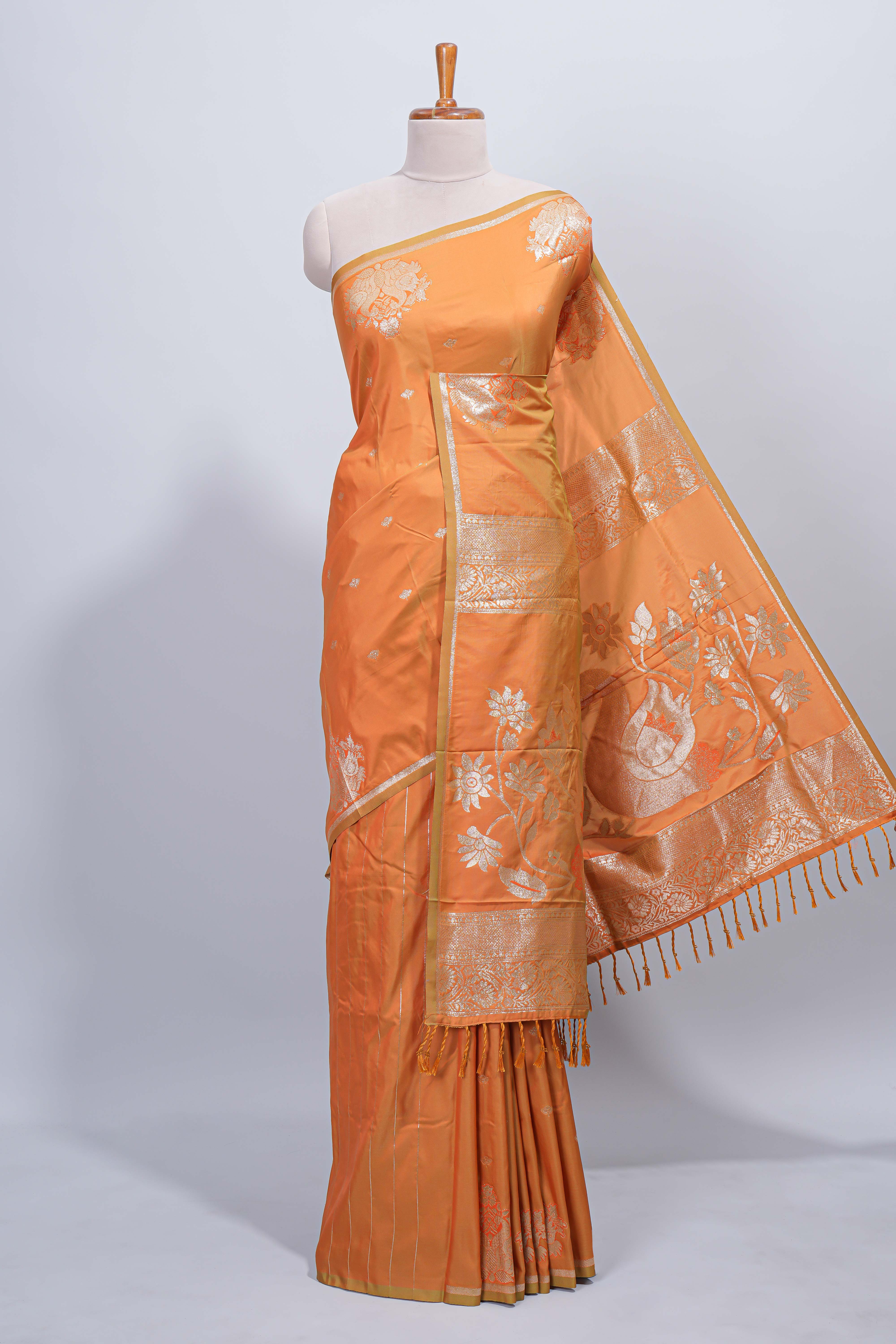 Light orange floral zari motifs design semi soft silk saree with self border and matching blouse