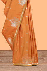 Rust Orange colour Semi soft silk withgold zari floral motifs border with peacock motifs and matching blouse